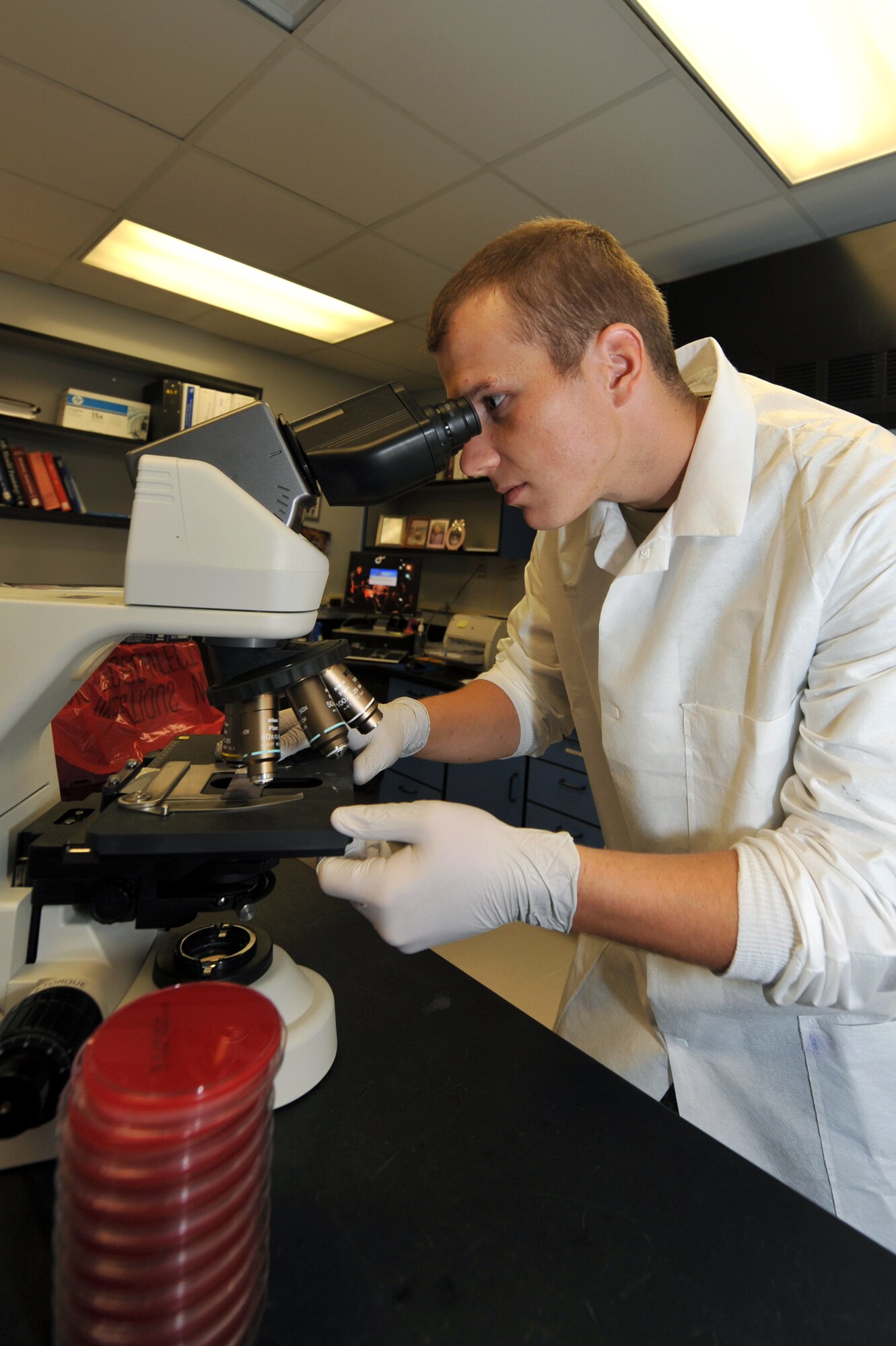 Airman 1st Class Abner Leps, 19th Medical Group lab technician, views training samples through a lab microscope Sept. 10. The 19th Medical Group laboratory provides more than 3,000 in-house lab test per month. (U.S. Air Force photo by Staff Sgt. Chris Willis)