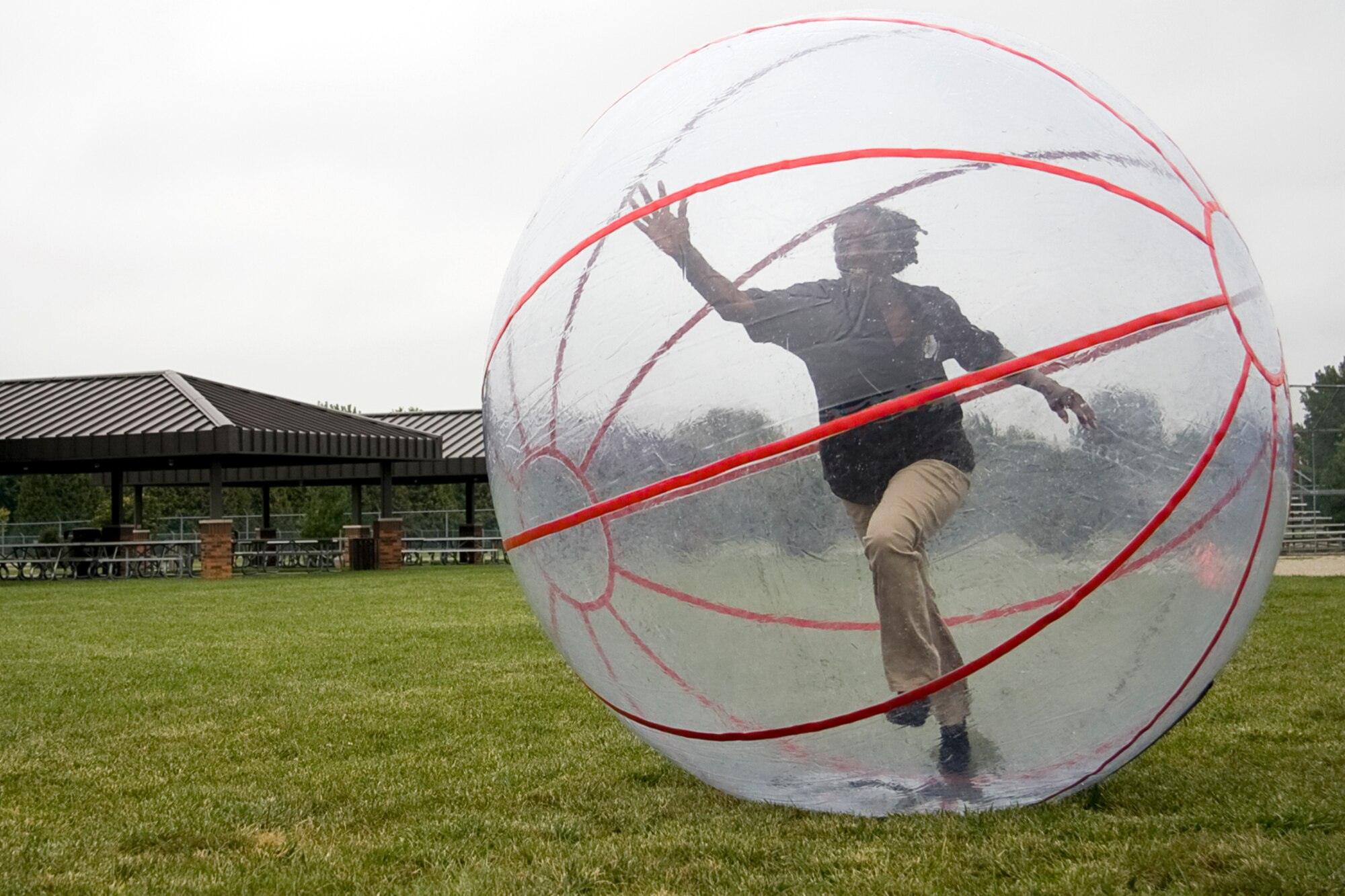 GRISSOM AIR RESERVE BASE, Ind. -- Chief Master Sgt. Tamara Jones races by during a sphere race Sept. 11 during the Grissom Family Day picnic. The sphere race pitted Airmen from the Mission Support, Operations and Maintenance Groups against each other in a hamster-inspired competition. In the end, it was the 434th MXG that rolled their way to the top prize. Chief Jones is the 434th Logistics Readiness Squadron supply management superintendent. (U.S. Air Force photo/Tech. Sgt. Mark R. W. Orders-Woempner)