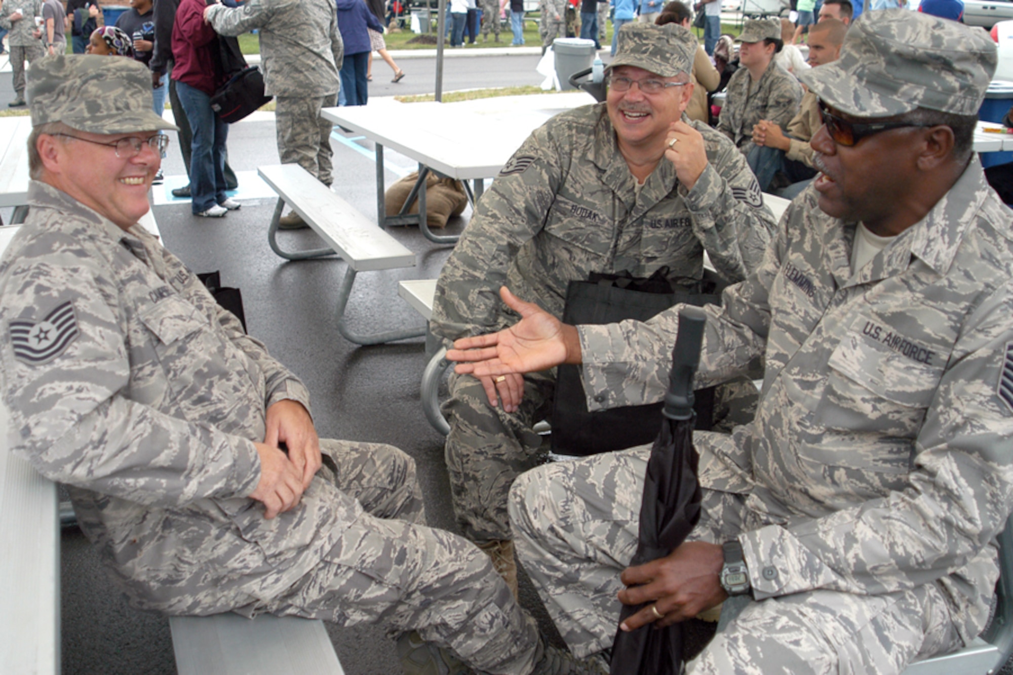 GRISSOM AIR RESERVE BASE, Ind. -- From left, Tech. Sgt. Howard Campbell, Staff Sgt. Stephen Hudak and Master Sgt. Donald Flemming share laughs during the Grissom Family Day picnic held here Sept. 11. Sergeant Flemming is a pavement and equipment craftsman, Sergeant Campbell is an electrician, and Sergeant Hudak is a heating, ventilating and air-conditioning technician. All three noncommissioned officers are assigned to the 434th Civil Engineer Squadron. (U.S. Air Force photo/Senior Airman Carl Berry)