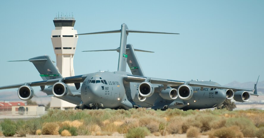 C-17s taxi before take-off to test the formation flight system, which enables the C-17 pilot to monitor and fly the aircraft in formation with other C-17s at the same altitude and distance in any weather condition.  (U.S. Air Force photo/Rob Densmore)