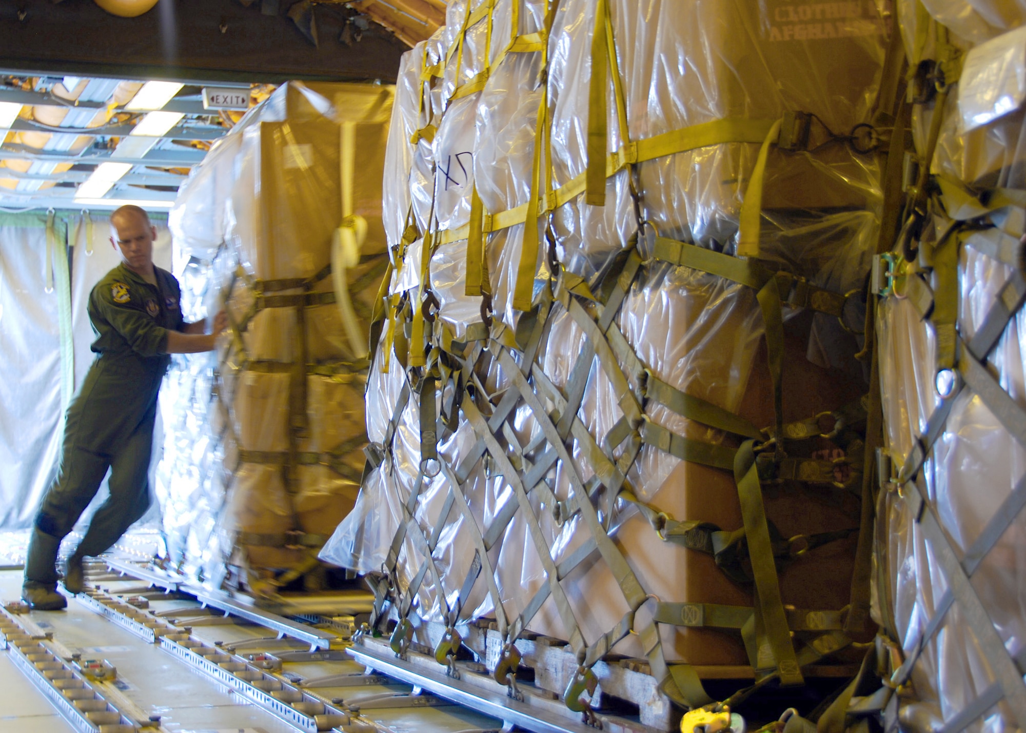 First Lt. Christopher McMenamy helps load humanitarian cargo onto a KC-10 Extender Sept. 2, 2010, at Joint Base McGuire-Dix-Lakehurst, N.J. The humanitarian cargo consisted of winter clothing, shoes and blankets that will be distributed to villages and orphanages near Kabul, Afghanistan. Lieutenant McMenamy is a KC-10 pilot from the 76th Air Refueling Squadron. (U.S. Air Force photo/Staff Sgt. Shawn J. Jones)