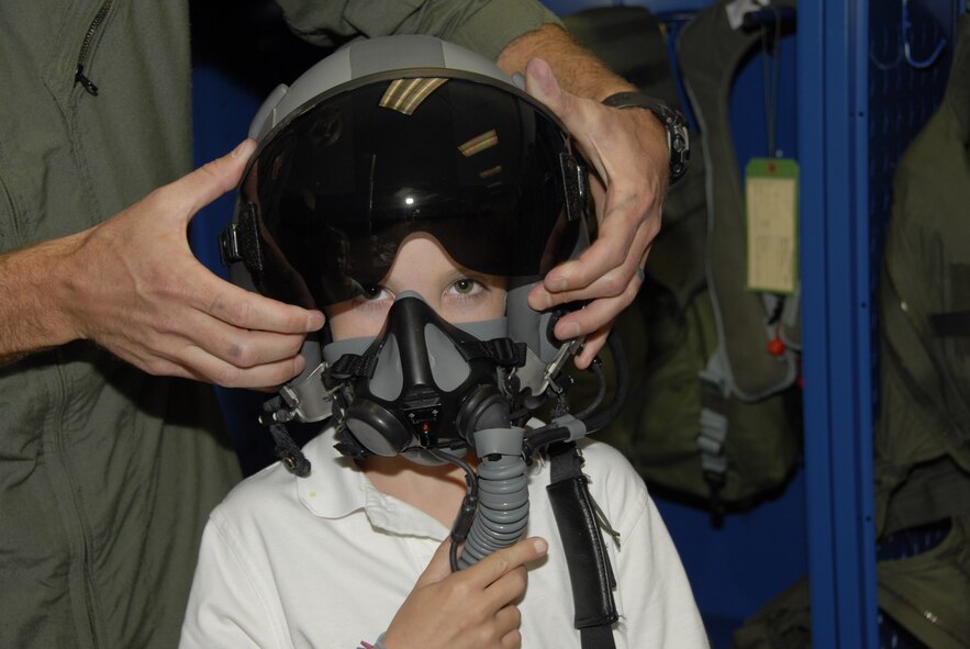 Major Adam Langton shows Preston Kilzer and his sister Kayli some aircrew flight equipment at the 125th Fighter Wing,Jacksonville Fla.  Preston and his family were in town with the Make A Wish Foundation and were given the opportunity to tour the base on September 13, 2010. (Air Force photo by Staff Sgt. Jaclyn Carver)