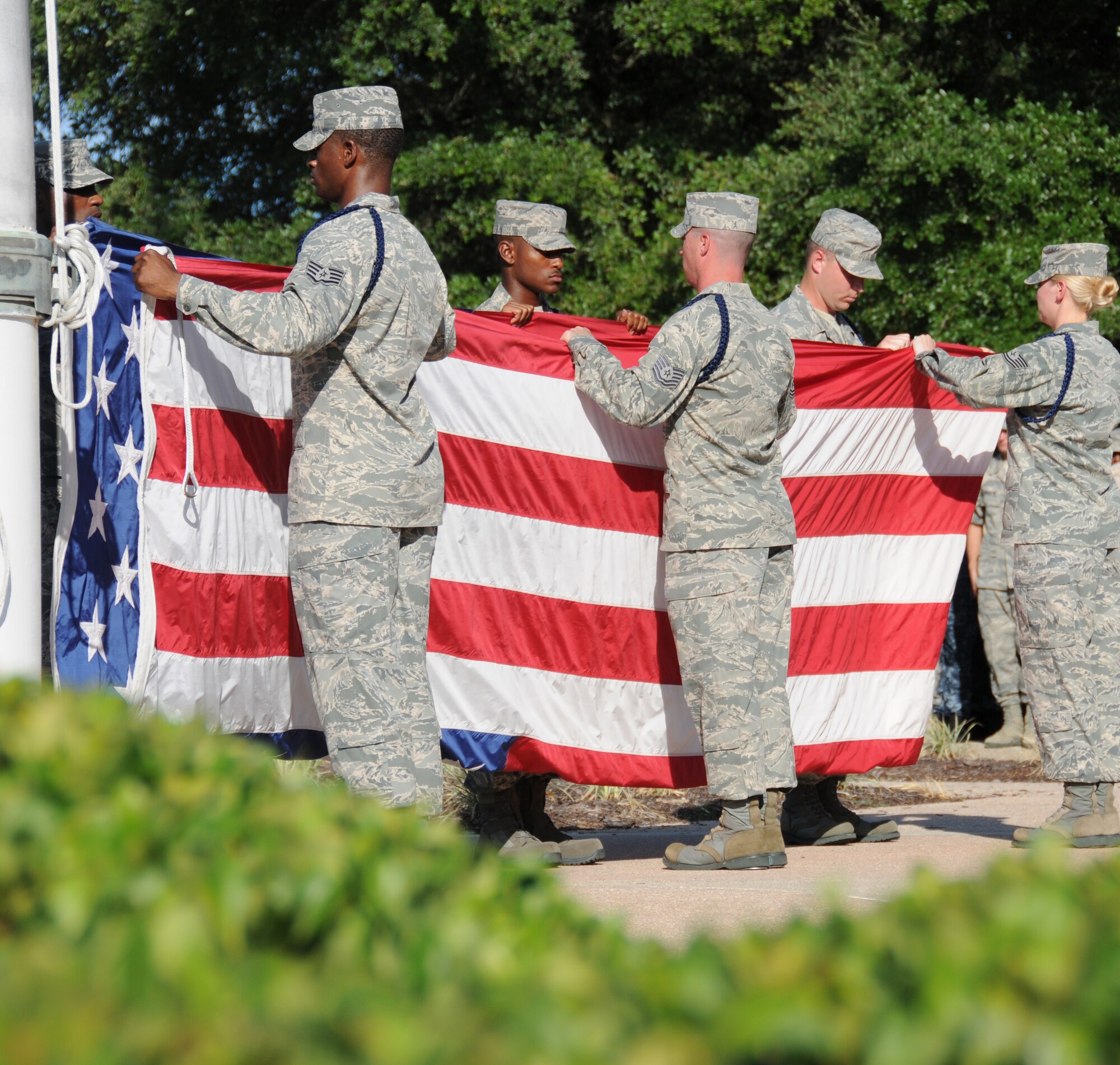 From left, Staff Sgts. Nicholas Wilson, Lamar Gardner and Marcus Jones and Tech. Sgts. James Hoover, Jed Moss and Joleen Giddens fold the flag during Friday’s formal retreat in front of 81st Training Wing headquarters to commemorate the Sept. 11, 2001, terrorist attacks on the United States and to honor all people who have given their lives in defense of America’s freedom.  Sergeants Wilson, Jones and Moss are 338th Training Squadron military training leaders.  Sergeans Gardner, Hoover and Giddens are MTLs in the 338th TRS.   (U.S. Air Force photo by Kemberly Groue)