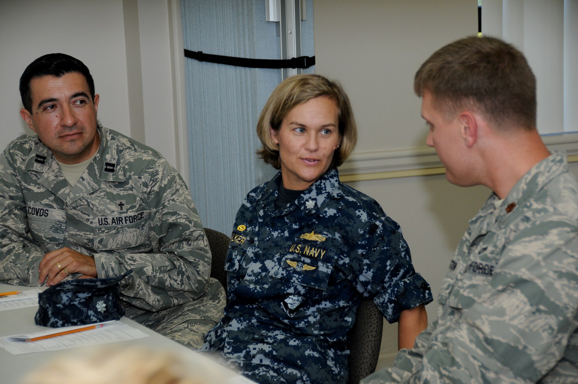 From left, Chaplain (Capt.) Ruben Dovos, Cmdr. Angie Walker and Maj. Matthew Stratton get acquainted during the chapel’s appreciation luncheon for commanders, chiefs and first sergeants, Sept. 9 in the Triangle Chapel Annex.  Commander Walker leads Keesler’s Center for Naval Aviation Technical Training Unit and Major Stratton commands the 335th Training Squadron.  (U.S. Air Force photo by Kemberly Groue)