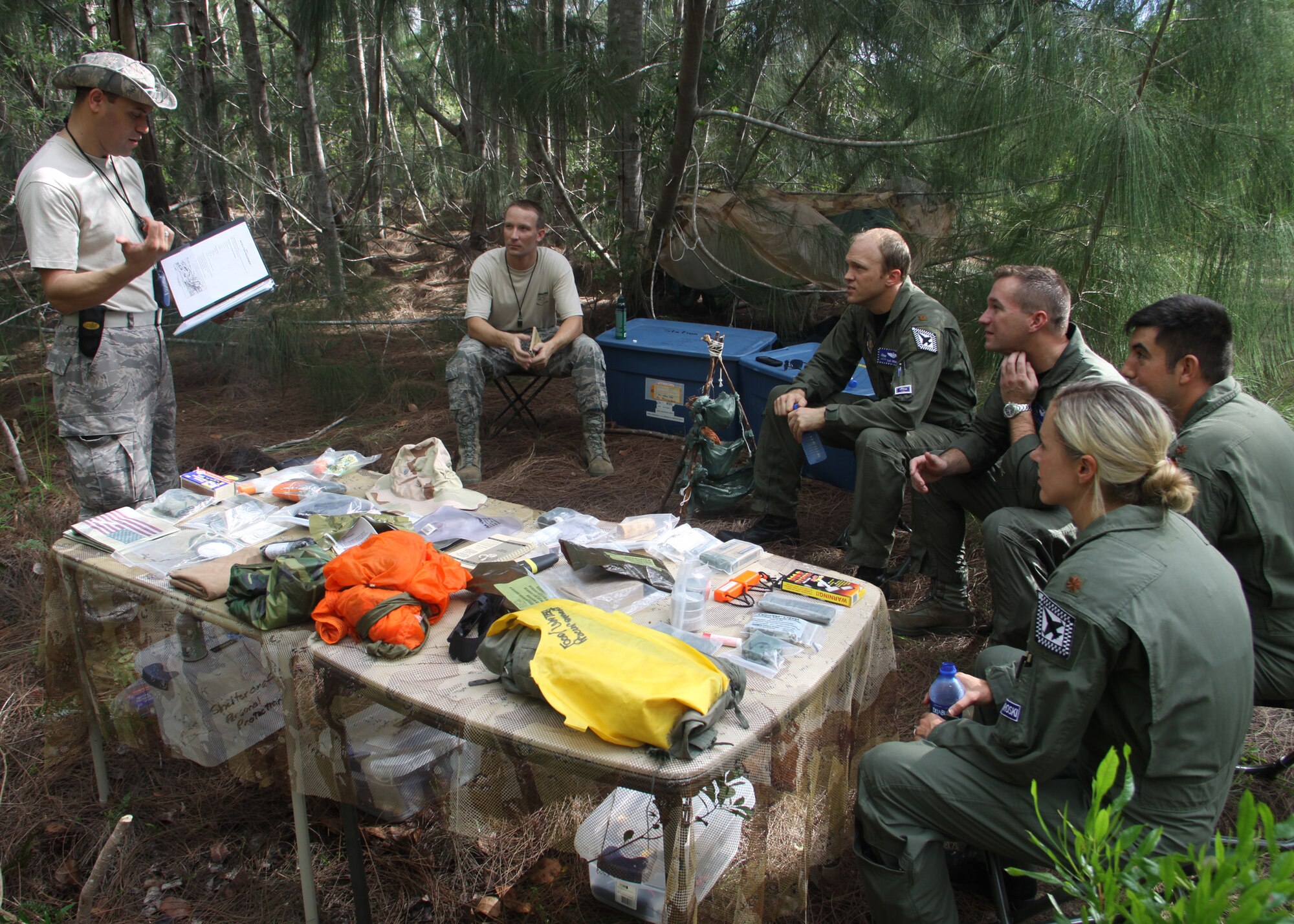 Tech. Sgt. Framis Ramos and Staff Sgt. Eric Little, 482nd Operations Support Squadron Aircrew Flight Equipment, instruct 93rd Fighter Squadron pilots how to collect water, food, and build shelter from available materials during Combat Survival Training at Homestead Air Reserve Base, Sep. 11. The training was part of a 2-day event that included signalling, survival kit familiarization, land navigation and land and water survival training. (U.S. Air Force photo / Tech. Sgt. Ian Carrier)
