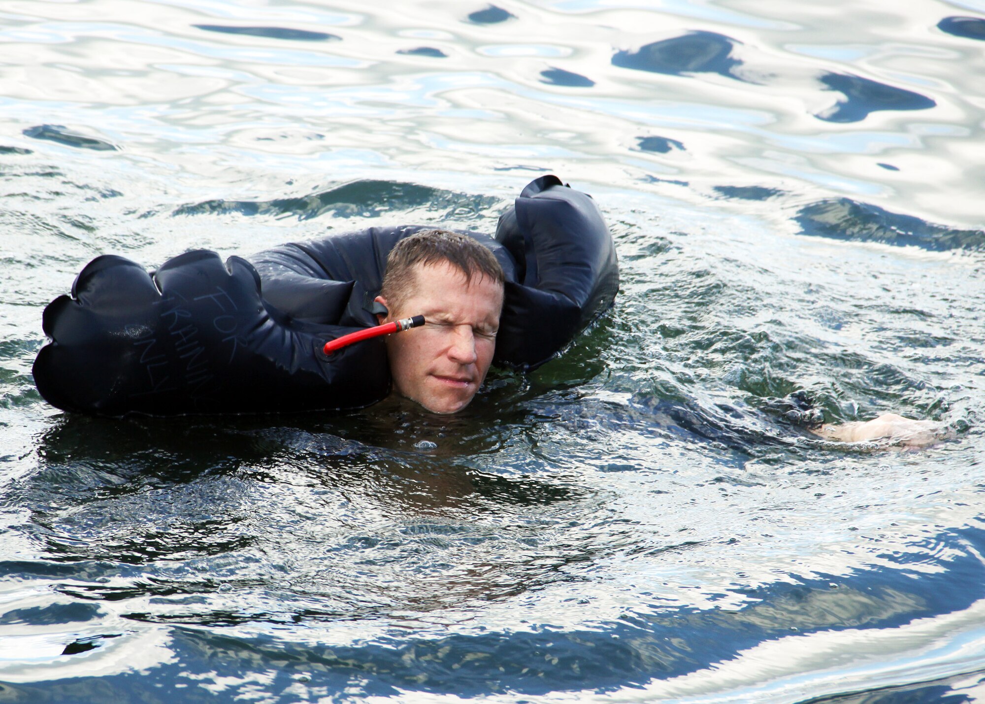 Maj. Matthew Fritz, 93rd Fighter Squadron, Homestead Air Reserve Base pilot, uses a floatation device during Water Survival Training, which took place in Key Largo, Sep. 11. The training was part of a 2-day event that included signalling, survival kit familiarization, land navigation and land and water survival training. (U.S. Air Force photo/ Tech. Sgt. Ian Carrier)
