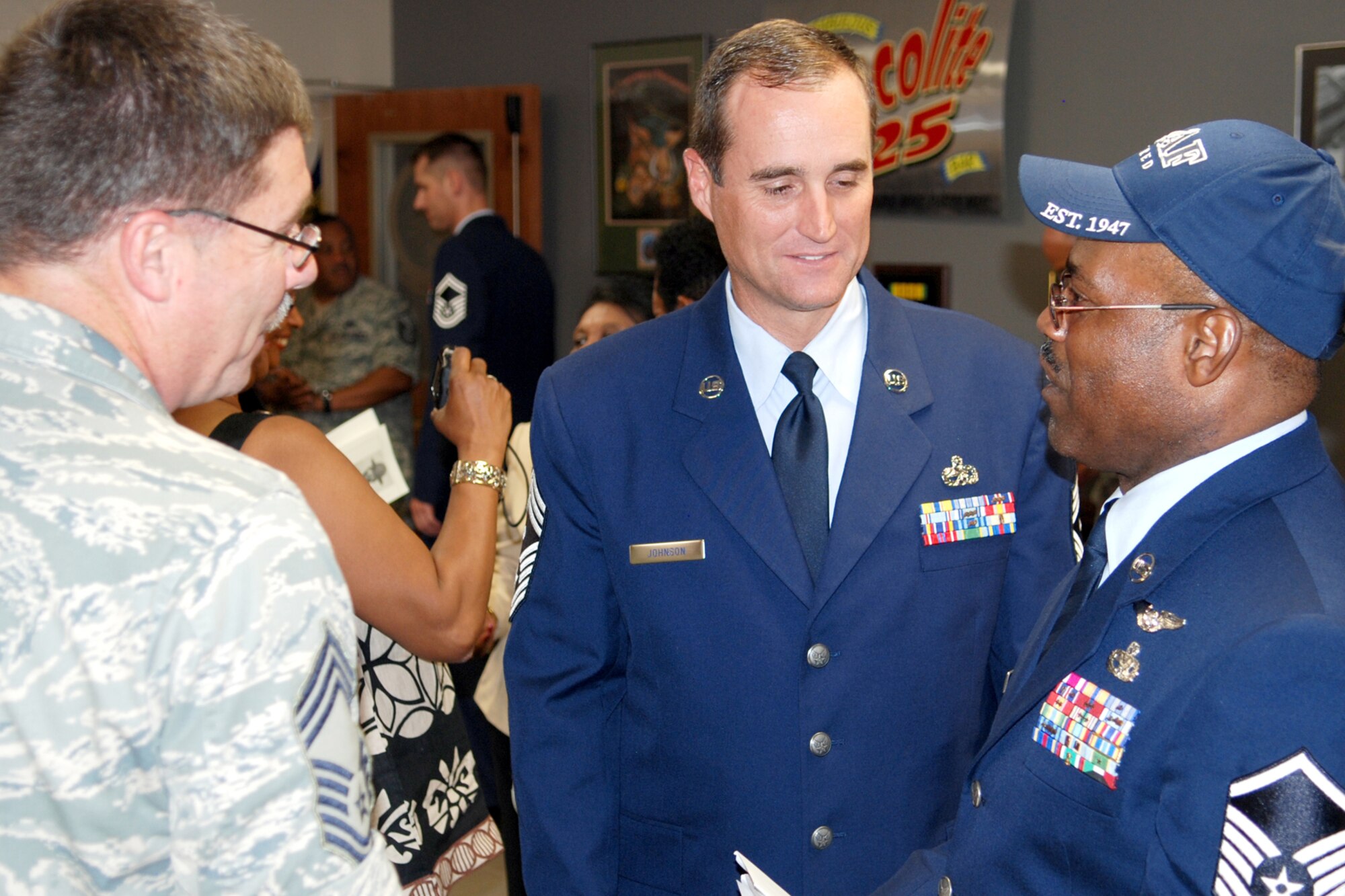 Chief Master Sergeants Stacy Bauer and Cary Johnson congratulate Master Sgt. (Ret) James W. Jones at the reception after his retirement ceremony at Barksdale Air Force Base, La., Sept. 11, 2010. Sergeant Jones, who began his military career in 1973 as a Marine, enlisted in the Air Force Reserves in 1984. At the time of his retirement, Sergeant Jones was the A-10 phase dock night shift phase coordinator for the 917th Maintenance Squadron at Barksdale. He was responsible for managing the scheduled maintenance of more than 25 A-10 aircraft and supervising 11 Airmen. Sergeant Jones was a member of the 926th Fighter Wing at New Orleans prior to its' closing under the Base Realignment and Closure that relocated to the 917th Wing. (U.S. Air Force photo by/Master Sgt. Greg Steele)    

