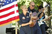 MINOT, N.D. – Tech. Sgt. Lara Murdzia and Airman 1st Class Jordan Kimble, both members of the United States Air Force Heartland of America Band Nightwing, sing a song for members of Minot AFB and the local Minot community during a concert in Oak Park here Sept. 11. The free concert was put on by the 91st Missile Wing as a way to remember the events of 9/11 and to thank the communities surrounding the base for their continued support. A concert was also held Sept. 10 in Stanley, N.D. (U.S. Air Force photo by Tech. Sgt. Thomas Dow)