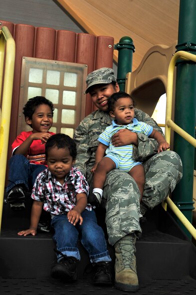 Senior Airman Sheila deVera, 1st Special Operations Wing Public Affairs photographer and single mother, gathers with her three sons, left to right, Brian Jr., 4, Daeshawn, 2, and Jaiden, nine months old, at a playground at Hurlburt Field, Fla., Sept. 15, 2010.  The Airman & Family Readiness Center holds a single parent support group meeting on the fourth Tuesday of every month for single parents to share their experiences and draw lessons from others. (DoD photo by U.S. Air Force Staff Sgt. Stephanie Jacobs) (RELEASED)