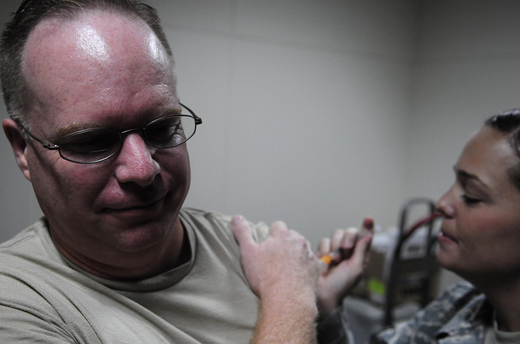 Col. Eric Beene, 39th Air Base Wing commander, receives an influenza vaccination from Staff Sgt. Christie Schlattweiler, 39th Medical Operations Squadron allergy and immunizations technician, Sept. 14, 2010 at Incirlik Air Base, Turkey.  This year’s vaccination includes both the seasonal flu and H1N1 flu virus strands.  The 39th Medical Group will begin flu vaccinations for all squadrons Sept. 30, 2010.  (U.S. Air Force photo by Senior Airman Ashley Wood/Released)