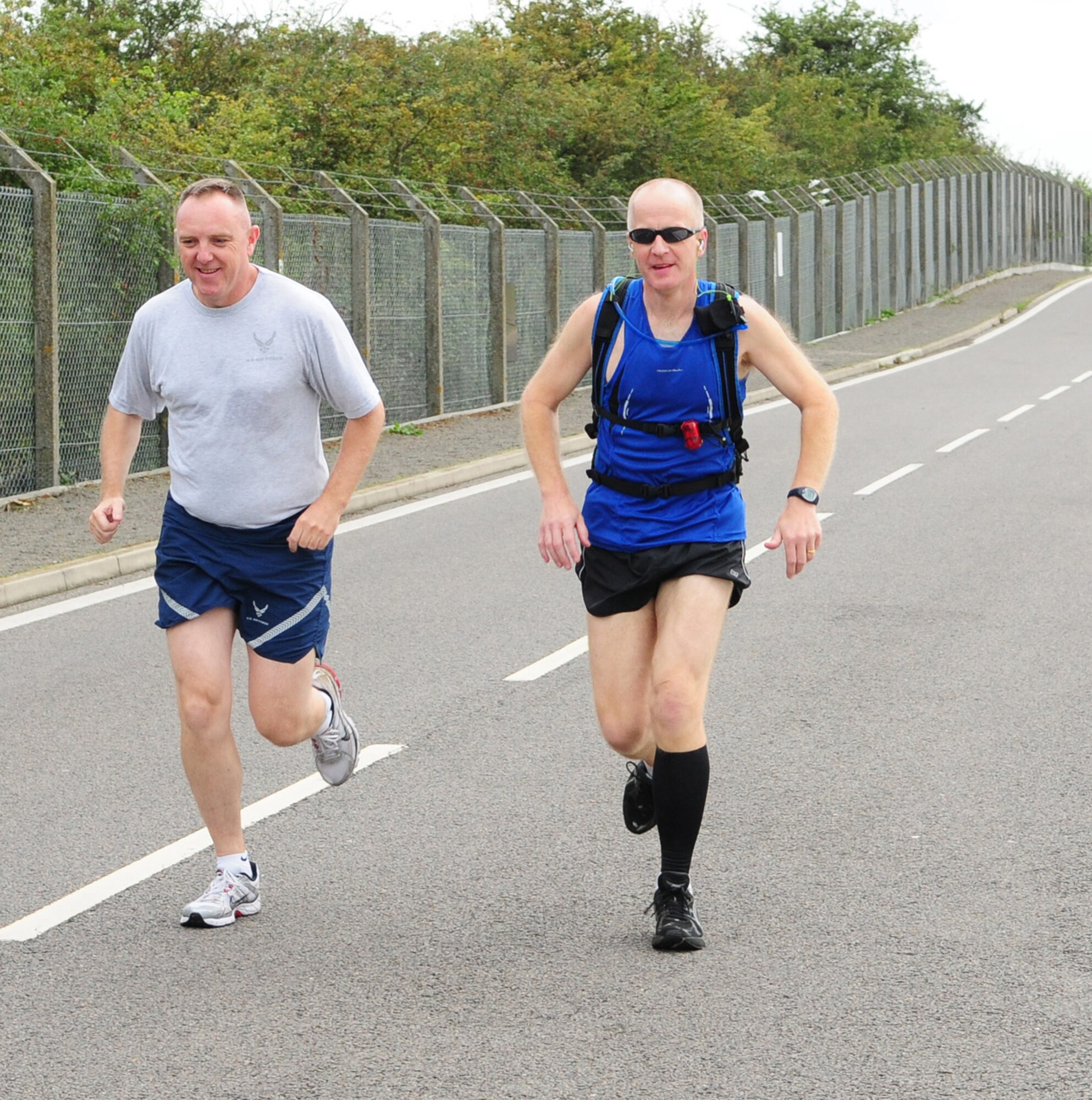 RAF MILDENHALL, England -- Lt. Col. Don Robertson, 100th Security Forces Squadron commander, and Sqdn. Ldr. Rick Fryer, RAF Mildenhall station commander, along with other wing leadership and base members, took part in the 100th Air Refueling Wing 5K run Sept. 10 on the south side of base. The monthly 5K is held to encourage health and fitness. (U.S. Air Force photo/Karen Abeyasekere)