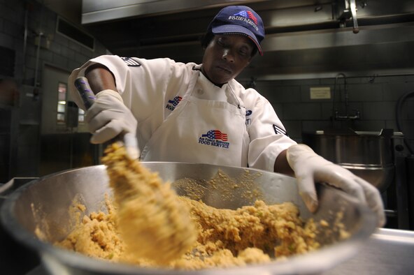 WHITEMAN AIR FORCE BASE, Mo., -- Staff Sgt. Shaundria Brentley, 509th Force Support Squadron, Food Services technician, mixes a bowl of stuffing for stuffed fish in preparation for midday chow at the Whiteman dining facility, Sept. 13. The 509th FSS Airmen operate with more than 400 recipes and prepare food for nearly 3,500 Airmen each week.  (U.S. Air Force photo by Senior Airman Kenny Holston)(Released)

