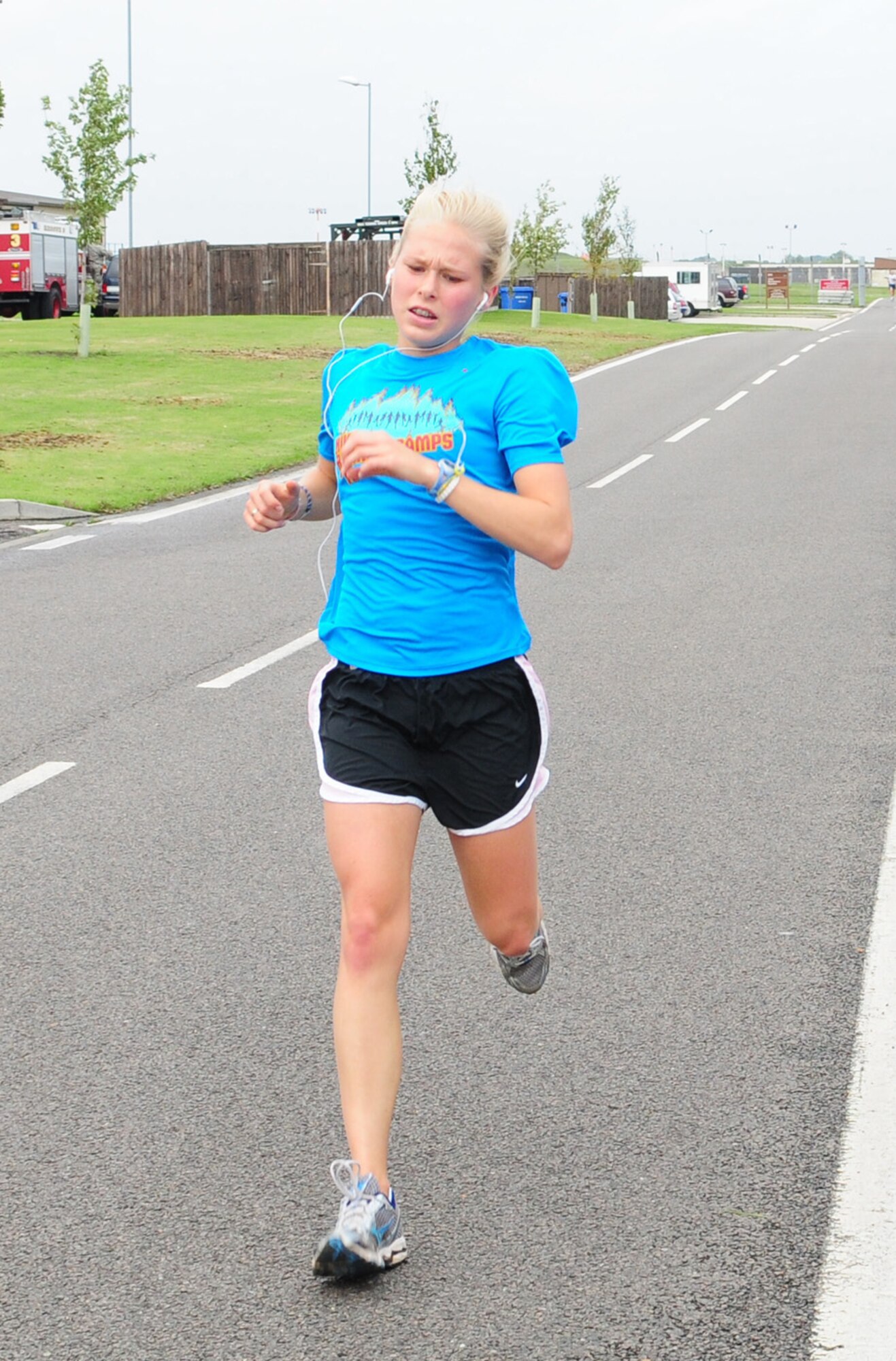 RAF MILDENHALL, England -- Elizabeth Doe, daughter of Col. David Doe, 100th Mission Support Group commander, finishes as the first female runner at the 100th Air Refueling Wing 5K run Sept. 10. Miss Doe completed the run in 20:54. (U.S. Air Force photo/Karen Abeyasekere)