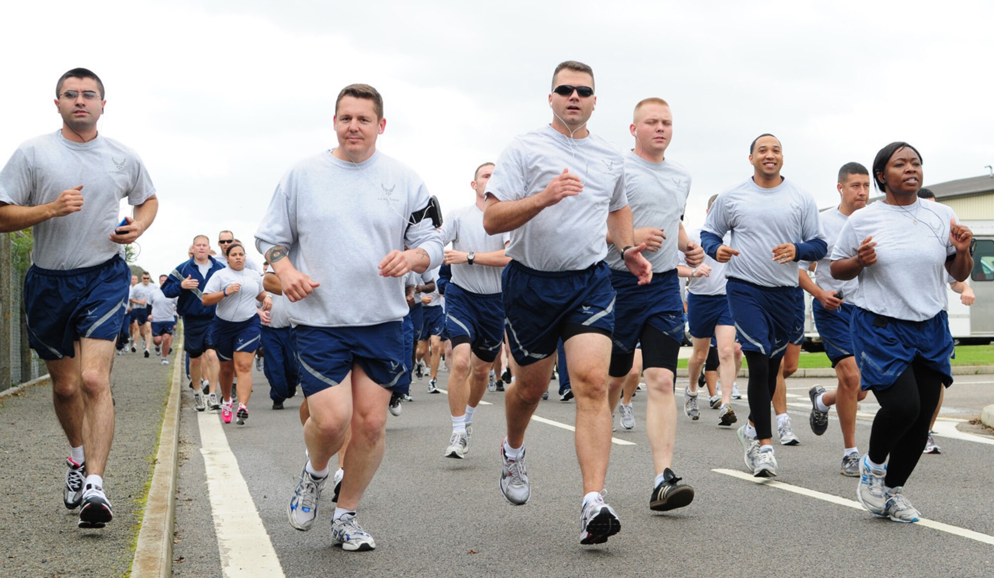 RAF MILDENHALL, England -- Members of the 100th Air Refueling Wing charge by en mass at the wing's 5K run Sept. 10. Base members, including commanders and first sergeants, took part in the run which is held monthly to promote health, fitness and camaraderie. (U.S. Air Force photo/Karen Abeyasekere)