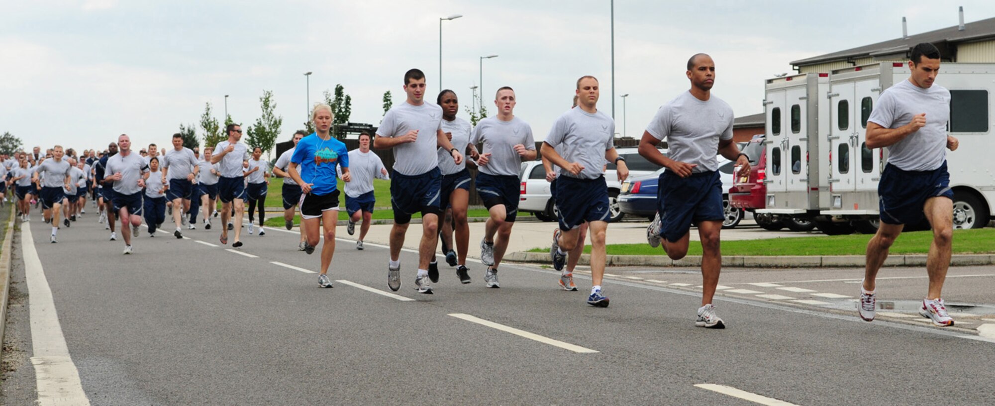 RAF MILDENHALL, England -- Team Mildenhall members start the 5K wing run Sept. 10 with a spring in their step. The monthly run, held on the south side of base along the perimeter road near Hangar 814, is for 100th Air Refueling Wing Airmen, tenant units, civilians and family members are also welcome to join. (U.S. Air Force photo/Karen Abeyasekere)