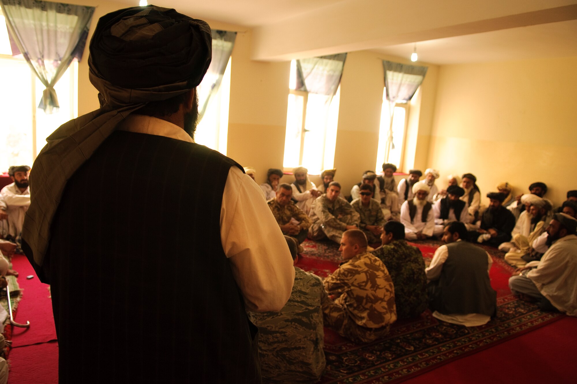 FORWARD OPERATING BASE BULLARD, Afghanistan - Shah Joy District Chief Abdul Qayum addresses a crowd of Afghan elders and coalition forces during an election shura at the Shah Joy District Center, Shah Joy District, Zabul province, Sept. 13. Qayum invited local elders to the district center to discuss the upcoming provincial parliamentary elections and to celebrate the end of Ramadan. (U.S. Air Force Photo/Senior Airman Nathanael Callon/Released)