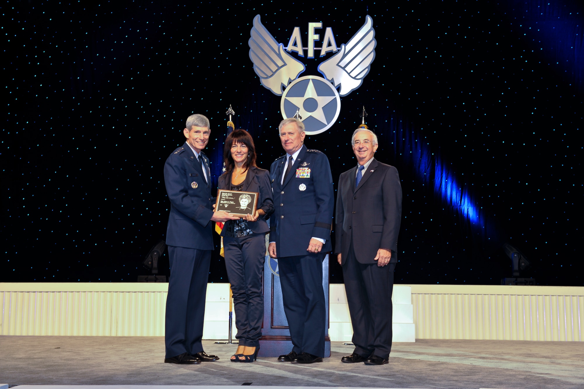WASHINGTON D.C. – Gen. Norton Schwartz, Air Force Chief of Staff, presents Mara Wight, wife of former 52nd Fighter Wing commander Col. Tip Wight, the 2010 Joan Orr spouse of the year award along with Gen. Roger Brady, U.S. Air Forces in Europe commander, and Joseph Sutter, Air Force Association chairman of the board, during the Air and Space Conference and Technology Exposition in Washington, D.C. Sept. 13. (courtesy photo)