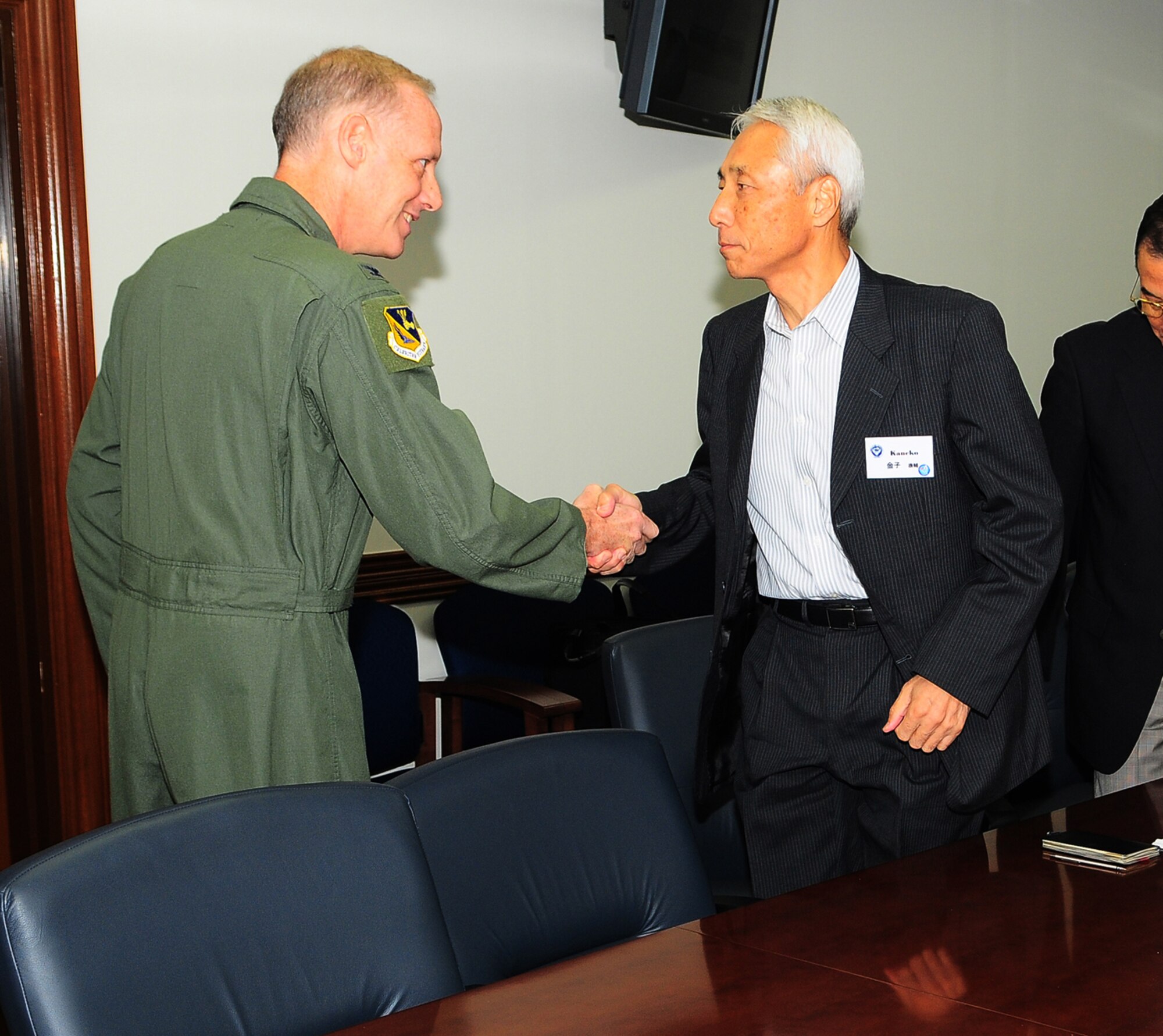 YOKOTA AIR BASE, Japan -- 374th Airlift Wing Commander Col. Otto Feather welcomes Japanese Air Self Defense Force Retired Col. Kosuke Kaneko and other members of the Japan Air Force Goodwill Association during their tour of Yokota Air Base September 15.  The JAAGA members enjoyed a 5th Air Force and 374 AW mission briefing, Air Defense Command relocation update and tour, as well as the opportunity for an up-close look at a C-130, UH-1 and C-12J. (U.S. Air Force photo by Staff Sgt Stacy Moless)