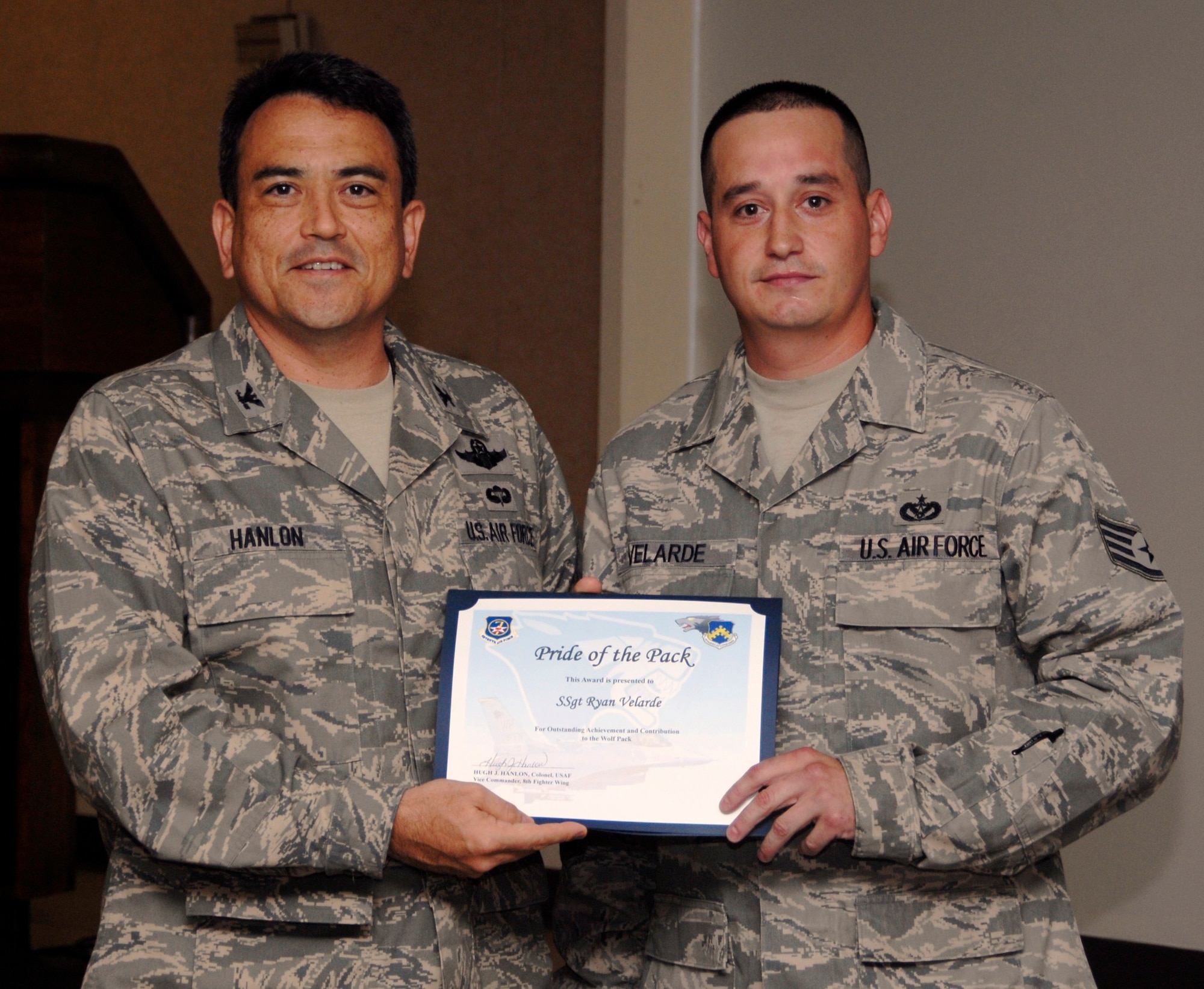 KUNSAN AIR BASE, Republic of Korea -- Col. Hugh Hanlon, 8th Fighter Wing vice commander, presents Staff Sgt. Ryan Velarde, 8th Civil Engineer Squadron Airman dorm leader, with a Pride of the Pack award Sept. 9. (U.S. Air Force photo/Staff Sgt. Amanda Savannah)