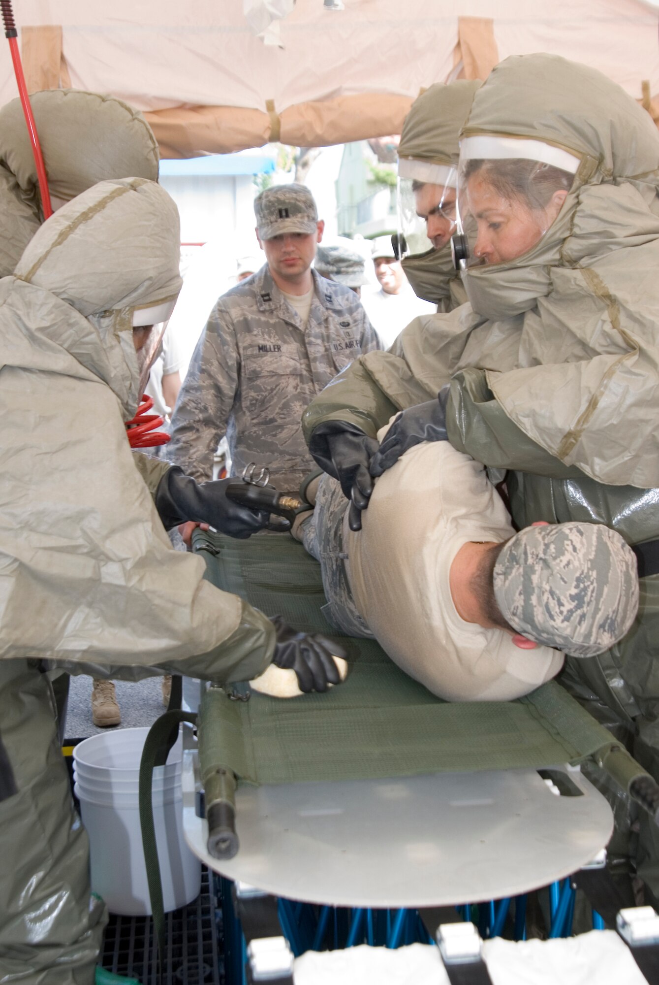 KUNSAN AIR BASE, Republic of Korea --   Capt. Garrett Miller, 51st Medical Operations Squadron, Osan Air Base, Korea, observes 8th Medical Group personnel as they simulate cleansing a contaminated military member during a decontamination exercise here Sept. 15.  Captain Miller led the training of the exercise which was meant to provide hands on training to medical personnel while using decontamination procedures.(U.S. Air Force photo/Staff Sgt. Jonathan Pomeroy)