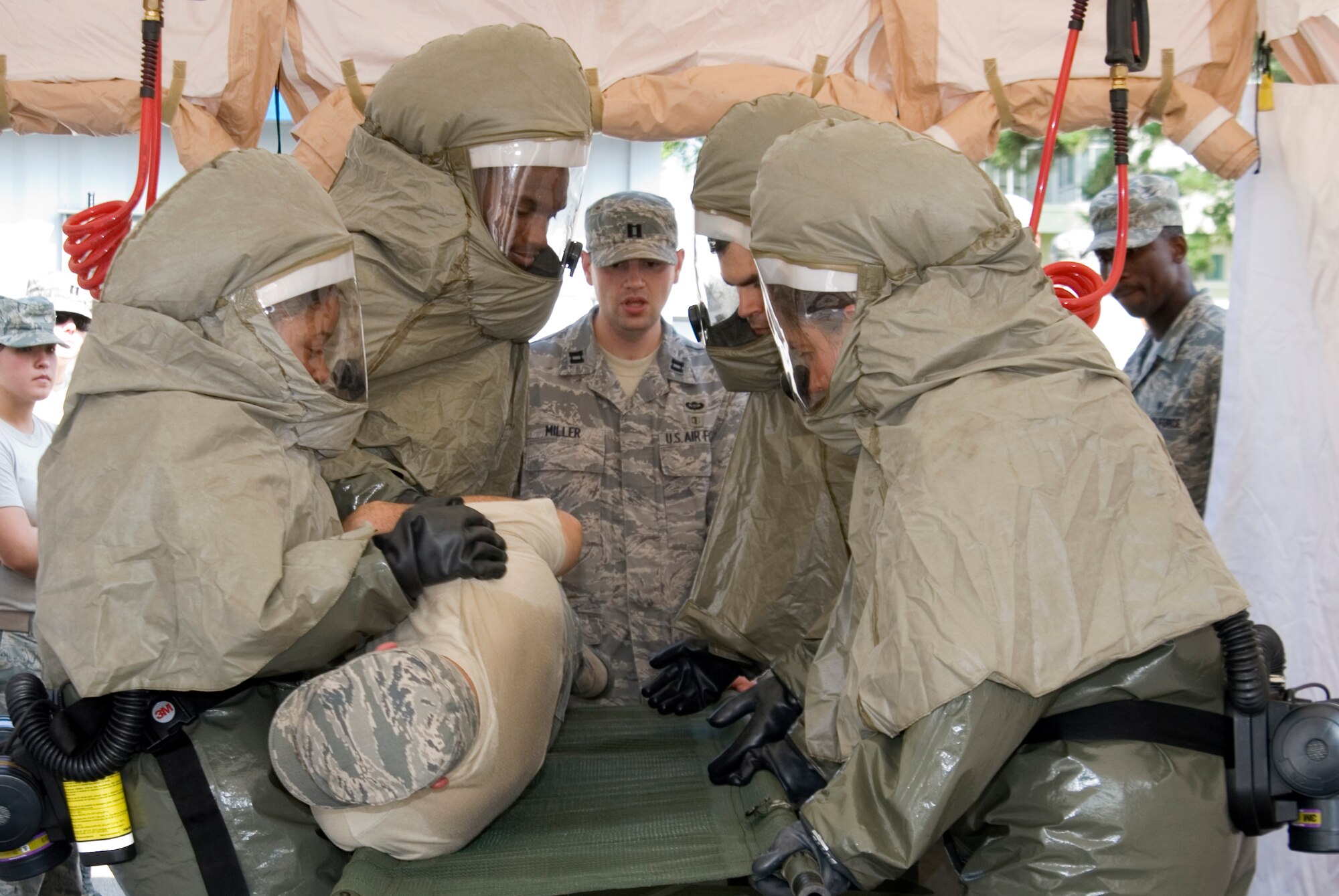 KUNSAN AIR BASE, Republic of Korea --   Capt.Garrett Miller, 51st Medical Operations Squadron, Osan Air Base, Korea, observes 8th Medical Group personnel as they simulate cleansing a contaminated military member during a decontamination exercise here Sept. 15.  Captain Miller led the training of the exercise which was meant to provide hands on training to medical personnel while using decontamination procedures.(U.S. Air Force photo/Staff Sgt. Jonathan Pomeroy)