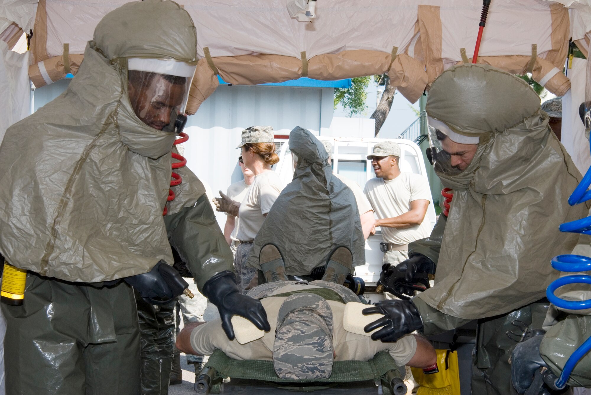 KUNSAN AIR BASE, Republic of Korea --   8th Medical Group personnel simulate cleansing a contaminated military member during a decontamination exercise here Sept. 15.  The exercise was meant to provide hands on training to medical personnel while using decontamination procedures.(U.S. Air Force photo/Staff Sgt. Jonathan Pomeroy)