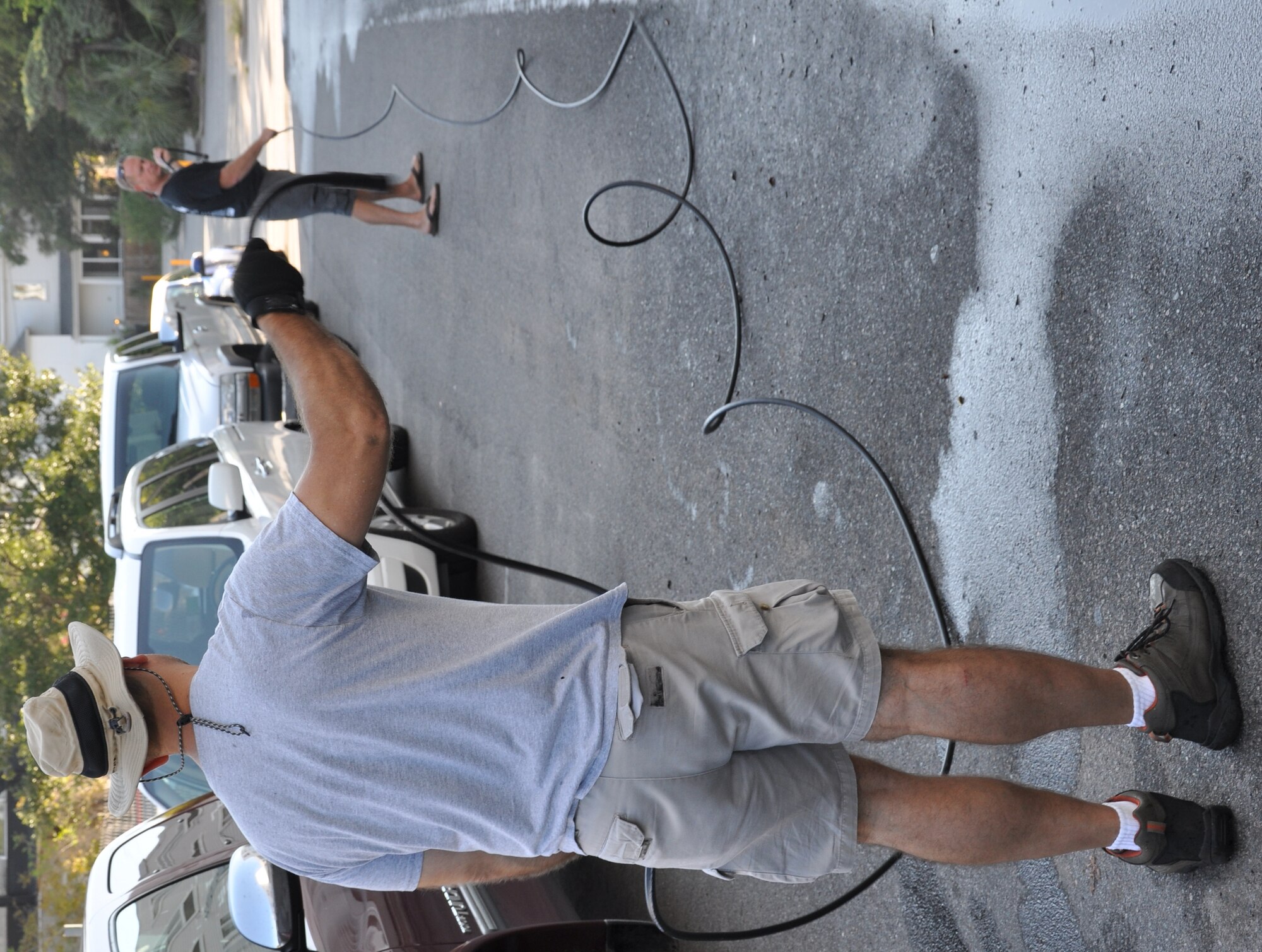Members of the 315th Airlift Wing prepare a hose they will connect to a pressure washer at the Ronald McDonald House of Charleston during the United Way’s 2010 National Day of Caring Sept 14, 2010 in the city of Charleston, S.C. (U.S. Air Force photo/Staff Sgt. Shane Ellis)