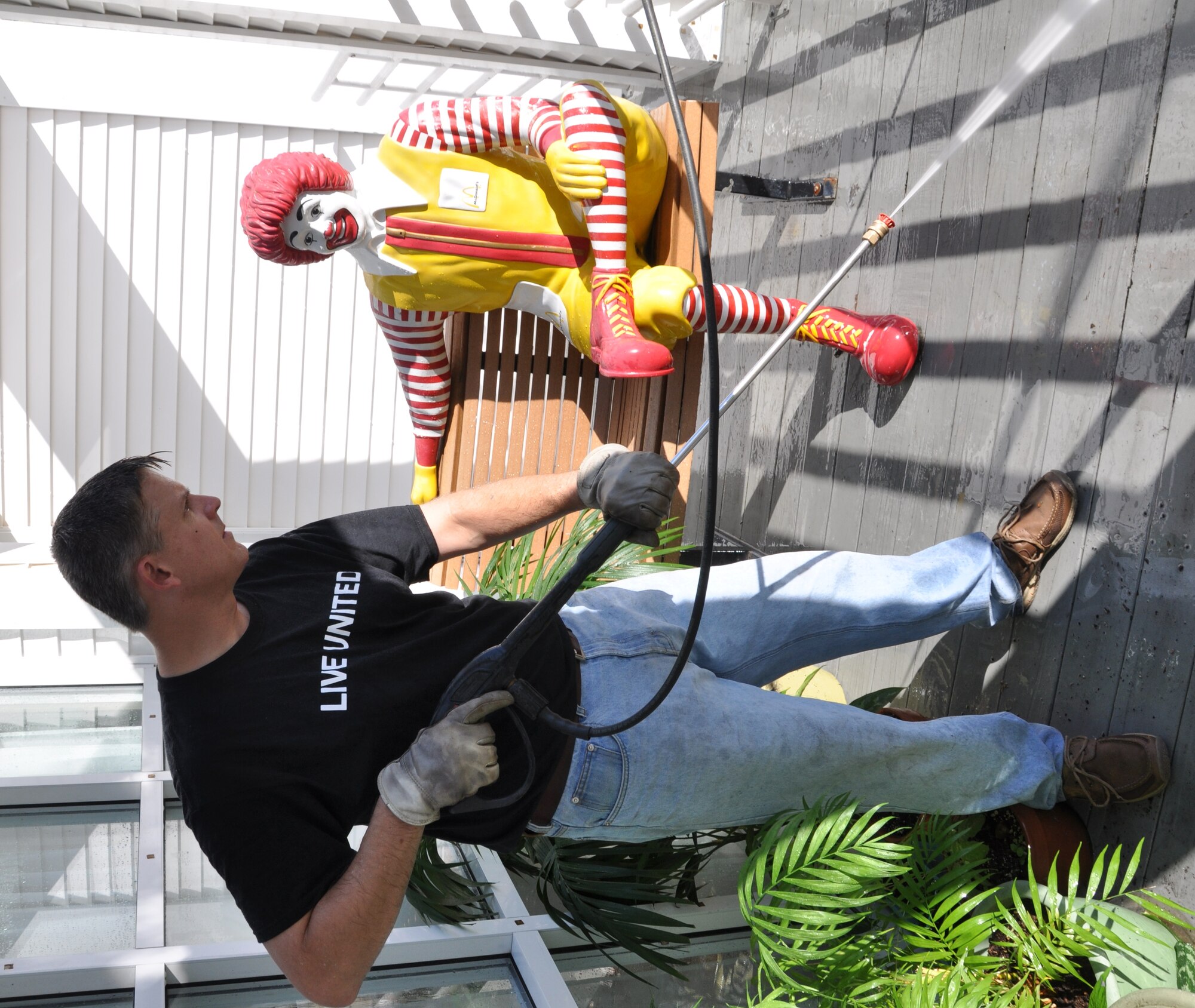 Master Sgt. Al McCourry pressure washes a deck at the Ronald McDonlad House of Charleston during the United Way's National Day of Caring Sept. 14, 2010 here. Sergeant McCourry is the first sergeant for the 701st Airlift Squadron. (U.S. Air Force photo/Staff Sgt. Shane Ellis)