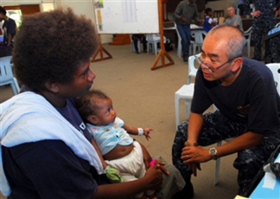 U.S. Navy Cmdr. Mark Nguyen (right) embarked aboard the Royal Australian Navy landing ship heavy HMAS Tobruk (L 50), consults with a patient during a medical civic action program at Malaguna Technical High School in Rabaul, Papua New Guinea, on Sept. 4, 2010.  Nguyen was part of a contingent of 64 sailors and nongovernmental organization members assigned to the Military Sealift Command hospital ship USNS Mercy (T-AH 19) that was embarked aboard Tobruk to conduct the final portion of Pacific Partnership 2010, a humanitarian and civic assistance operation designed to strengthen regional partnerships.  