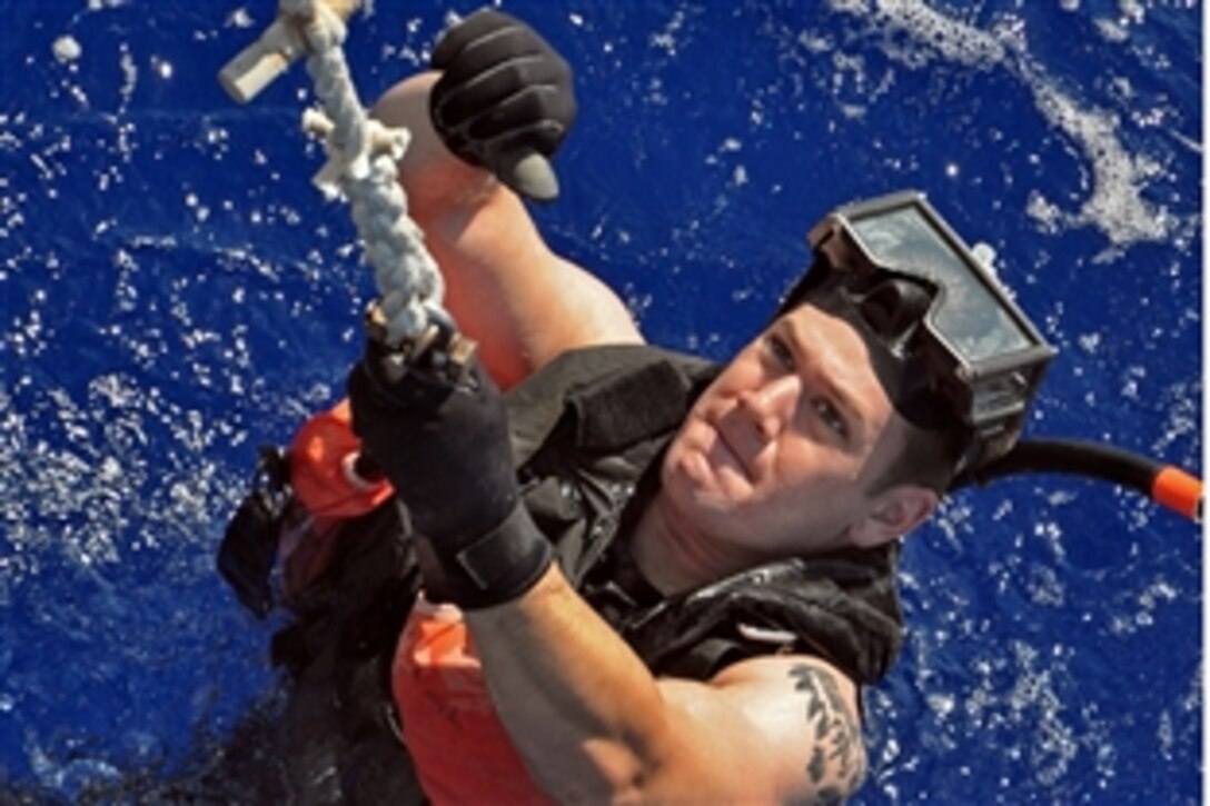 U.S. Navy Petty Officer 2nd Class Collin Reed gives a thumbs-up to signal a successful insertion into the water from the bow of the amphibious transport dock ship USS Ponce in the Mediterranean Sea, Sept. 14, 2010. The Ponce is part of the Kearsarge Amphibious Ready Group en route to provide food, water, and heavy-lift equipment to support humanitarian relief efforts for flood victims in Pakistan.