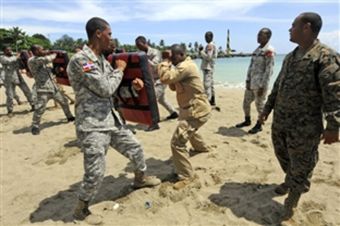 U.S. Marine Corps Sgt. Juan Martinez, right, observes members of the Dominican Republic military during a Marine Corps martial arts subject matter expert exchange in Santo Domingo, Dominican Republic, Sept. 13, 2010.