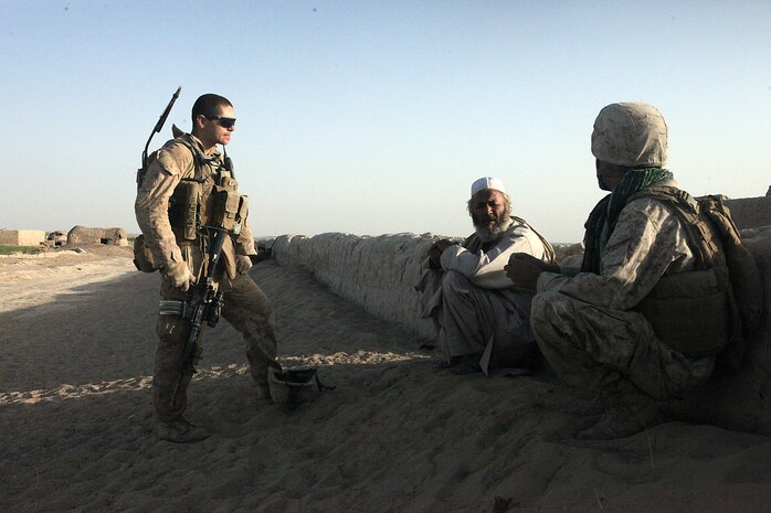 Sgt. Nathan D. McLain, a squad leader with Weapons Platoon, Company B, 1st Light Armored Reconnaissance Battalion, talks with a village elder in Shabu, Afghanistan, Sept. 15. Marines talk to the village elders and citizens of Shabu every day during their patrols.