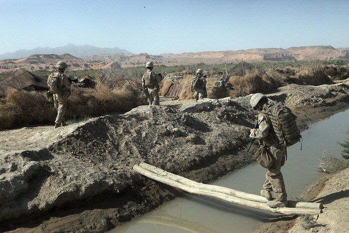 Marines with Weapons Platoon, Company B, 1st Light Armored Reconnaissance Battalion, patrol toward the village of Shabu, Afghanistan Sept. 15. Twice a day the Marines patrol several miles to get to Shabu to maintain village security.