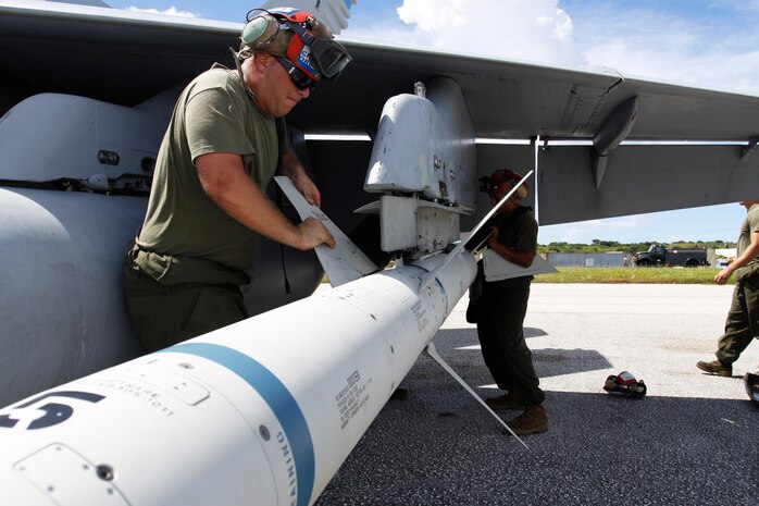 Cpl. Michael Krenz, a Marine All Weather Fighter Attack Squadron 225 aviation ordnance technician places works on adjusting the wings of an Air to Group High-speed Anti- Radiation 88 Missile at the flight line here during exercise Valiant Shield 2010 Sept.16. The F/A-18 to which the HARM AGM-88 is attached to is slated to participate in a Valiant Shield scenario designed to improve joint operation proficiency between all military services involved.