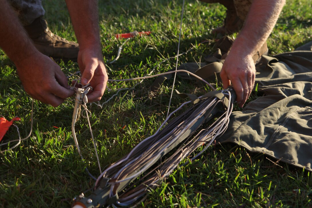 Communication Marines with the 22nd Marine Expeditionary Unit, untangle antennae support ropes in preparation for a communications exercise aboard Camp Lejeune, N.C., Sept. 15, 2010. The exercise was designed to familiarize the Marines with equipment they may use during their future deployment.