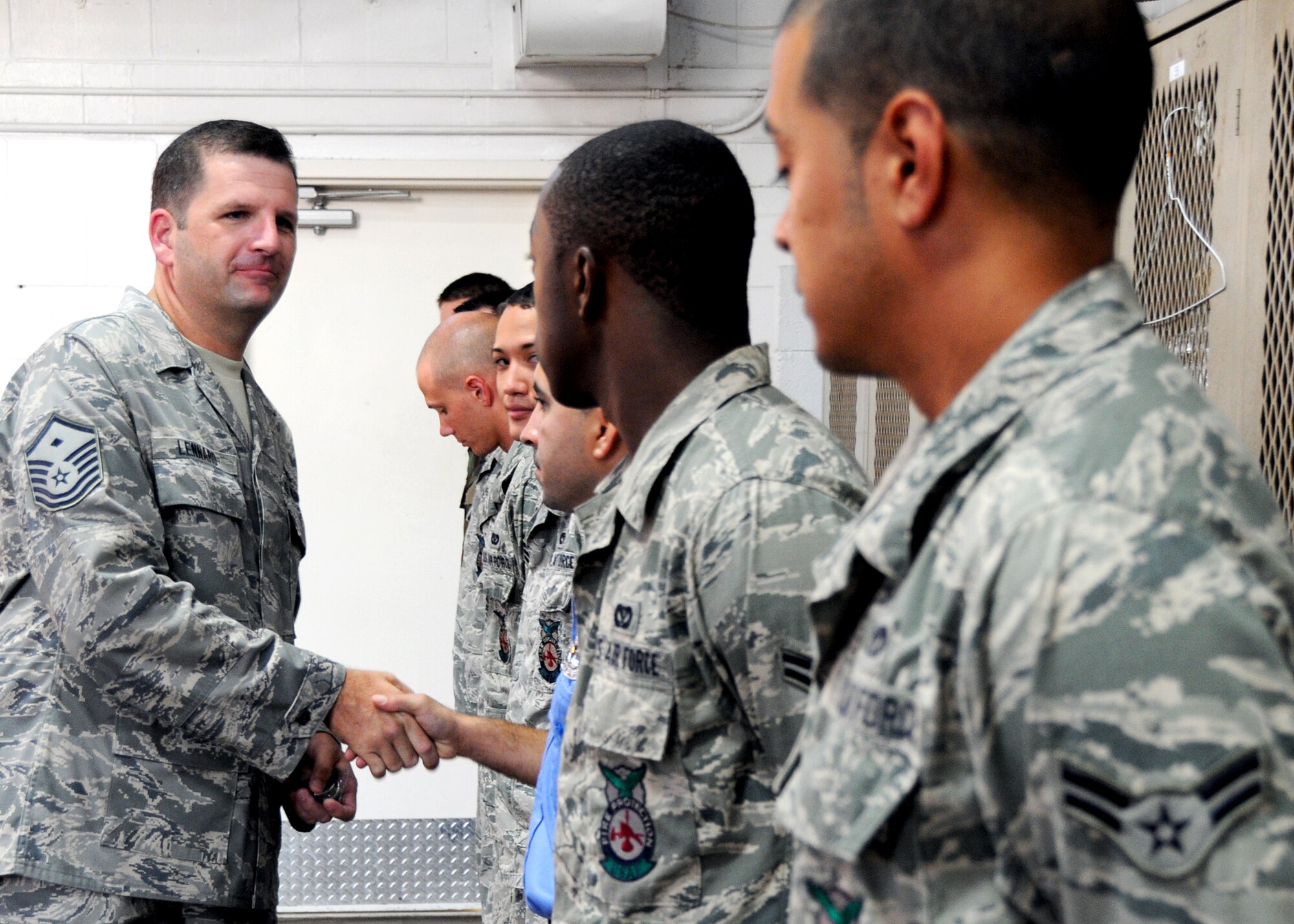 Master Sgt. Charles Lennard, 919th Civil Engineer Squadron first sergeant, congratulates members of his squadron's fire department for earning the First Sergeant's Diamond Sharp award for September.   During unit training assemblies, the First Sergeants Council honors selected Airmen who exceed standards and reflect positively on all their fellow Airrmen. This is the first time an entire flight has received the award.  (U.S. Air Force photo/Tech. Sgt. Samuel King Jr.)
