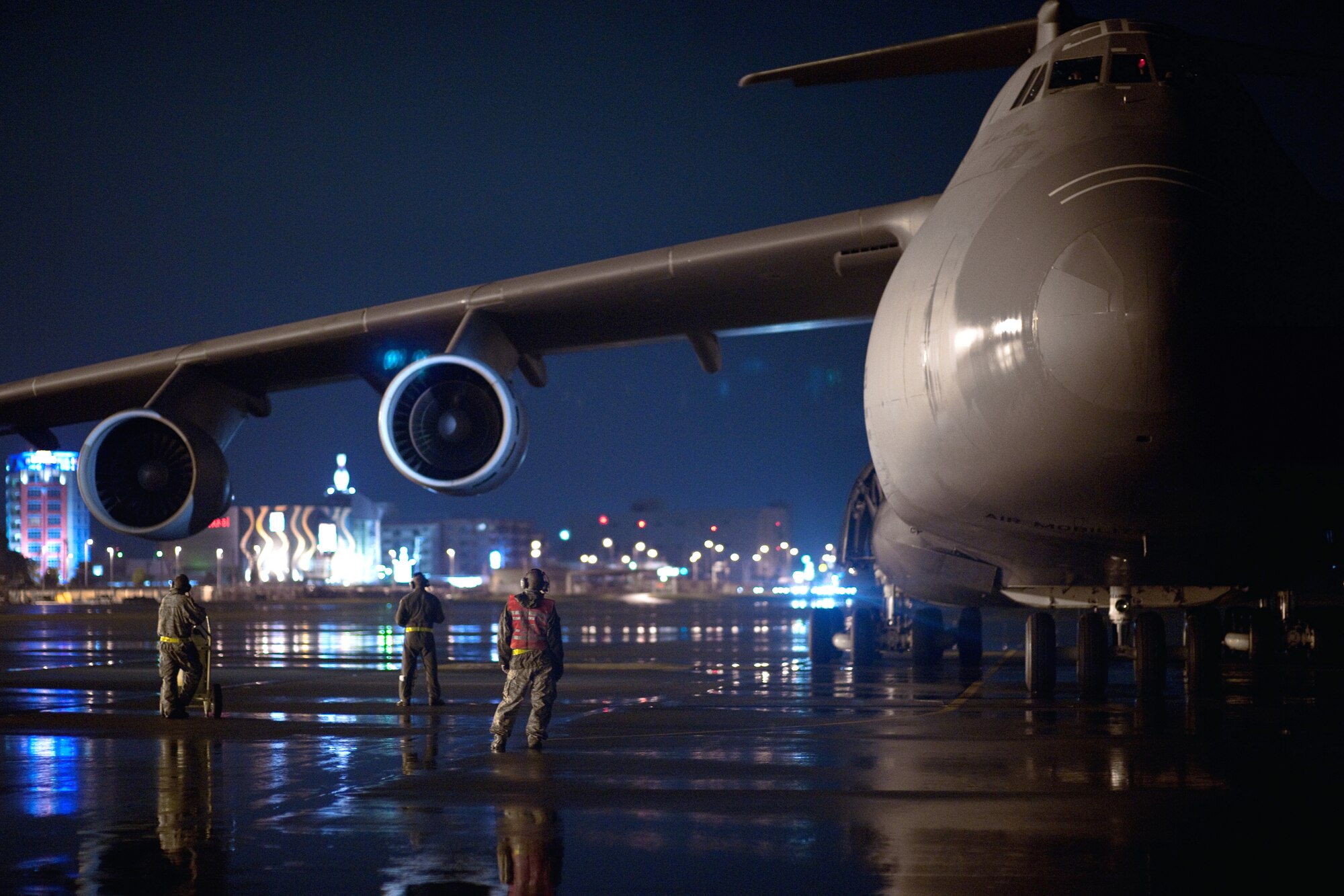 YOKOTA AIR BASE, Japan -- C-5 Galaxy crew member and 730th Air Mobility members perform the finial aircraft inspection before departure here Sept. 15.  As the airlift hub of the western Pacific, Yokota Airmen work 24/7 operations to keep inbound and outbound aircraft running.  (U.S. Air Force photo/Osakabe Yasuo)