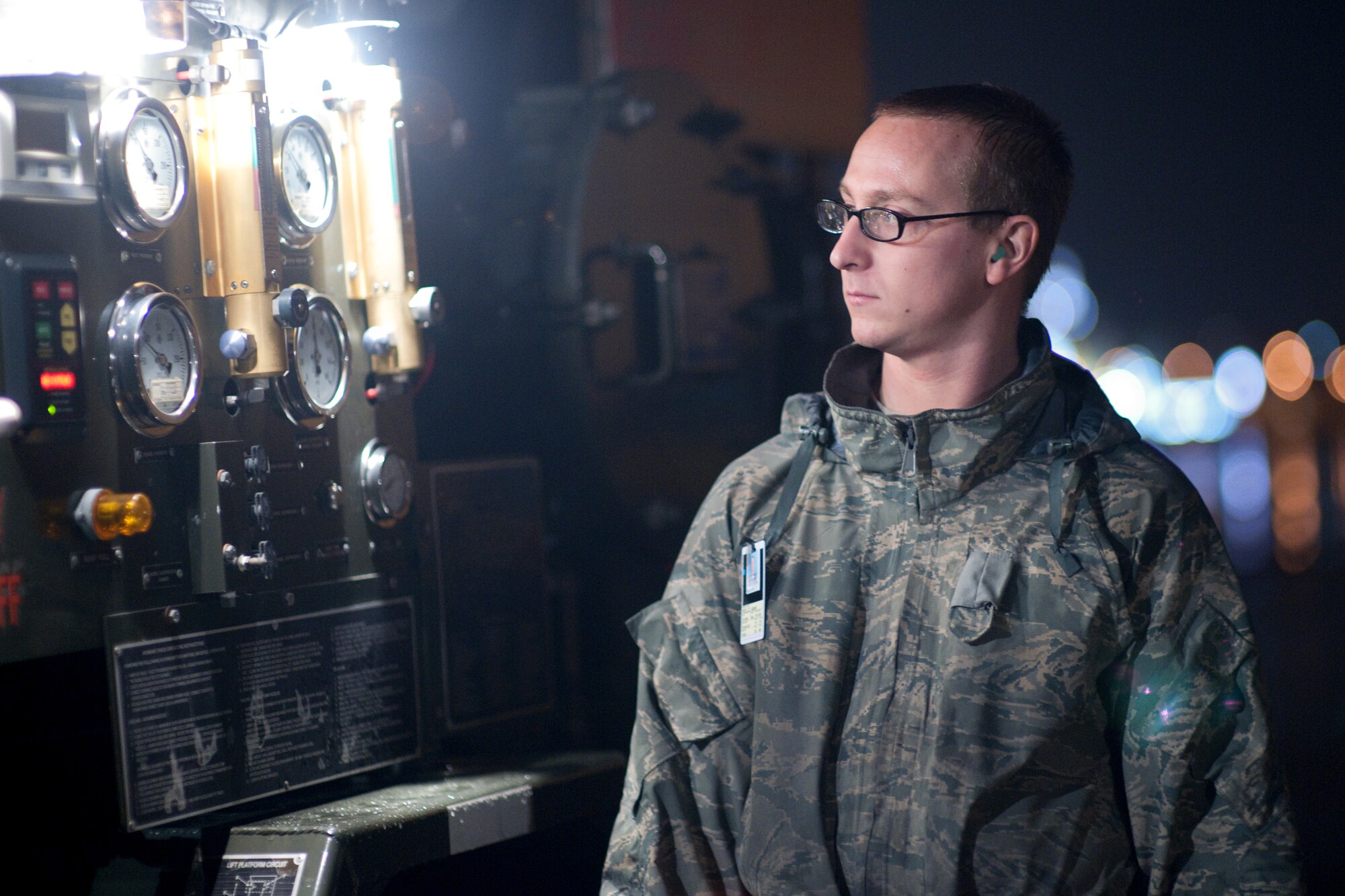 YOKOTA AIR BASE, Japan -- Airman Adam Rollo, 374th Logistics Readiness Squadron, monitors the pressure gauges on an R-12 Hydrant Servicing Vehicle here Sept. 15. As the airlift hub of the western Pacific, Yokota Airmen work 24/7 operations to keep inbound and outbound aircraft running.  (U.S. Air Force photo/Osakabe Yasuo)