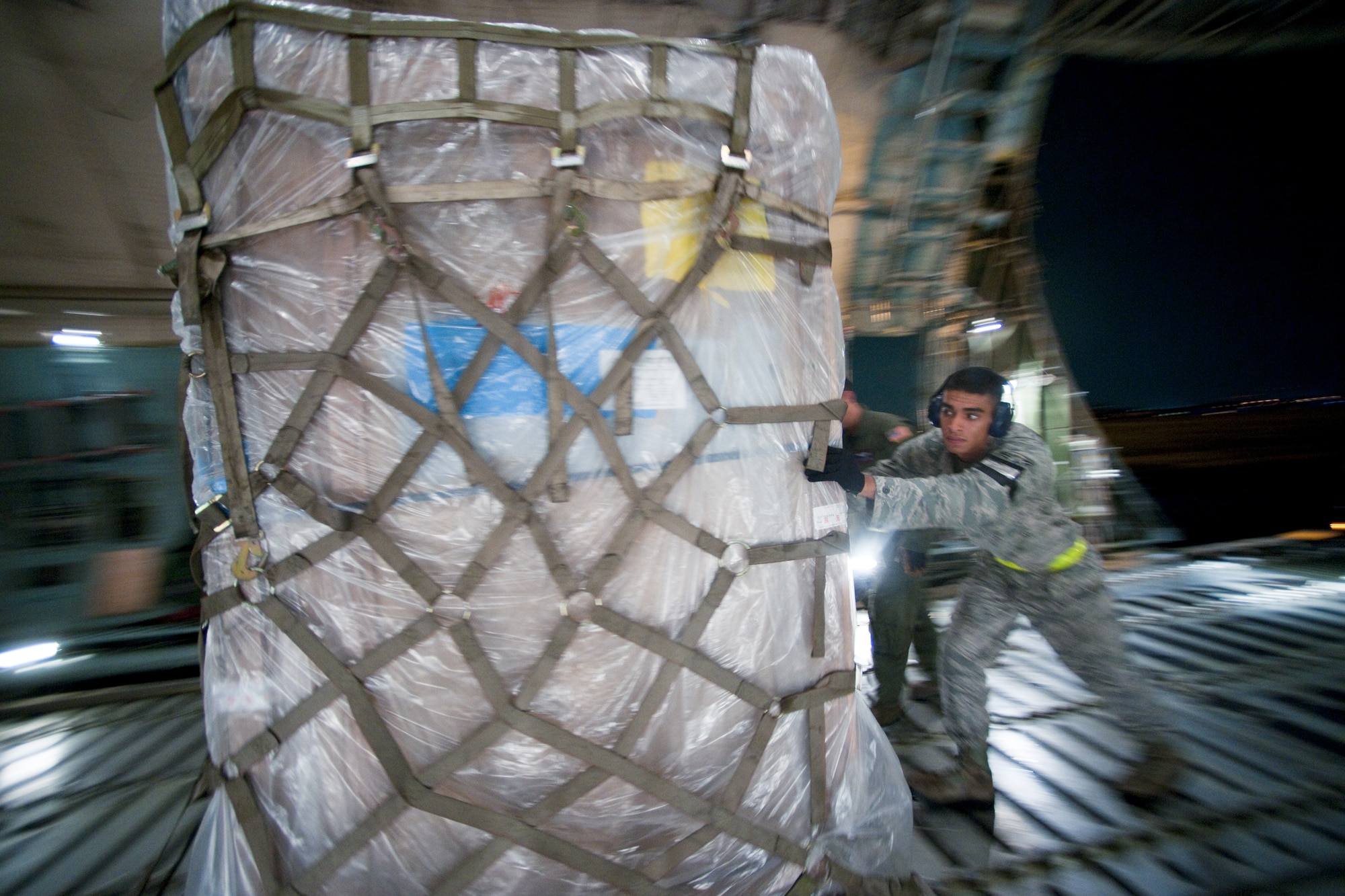 YOKOTA AIR BASE, Japan -- Airman 1st Class Paul Madriles, 730th Air Mobility Squadron, load pallets onto a C-5 Galaxy here Sept. 15. The members performed a two hour quick turn on the C-5 during a normal work day. (U.S. Air Force photo/Osakabe Yasuo)