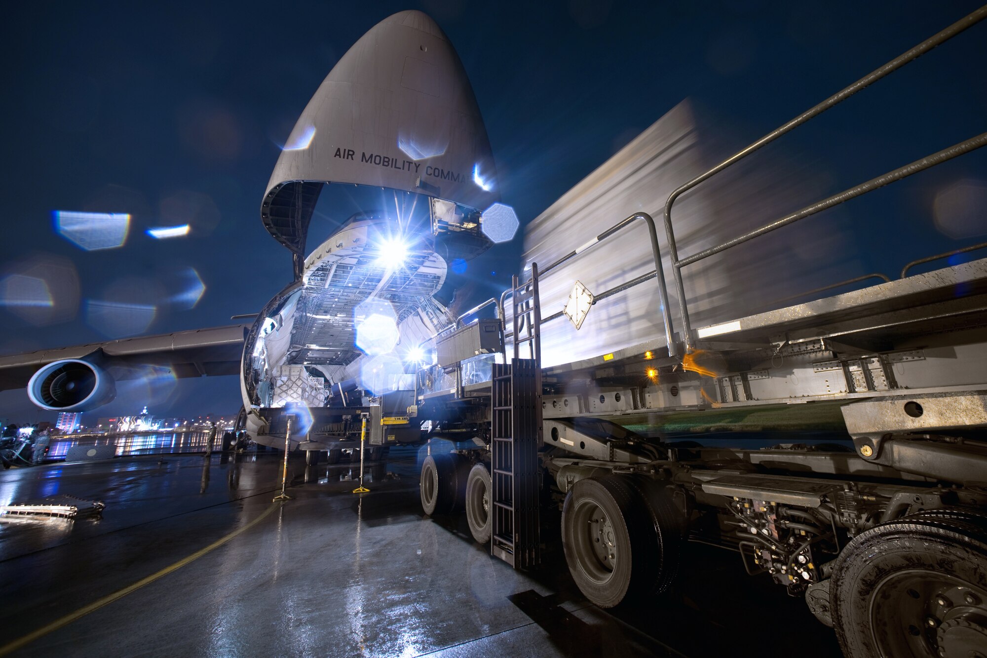 YOKOTA AIR BASE, Japan -- 730th Air Mobility Squadron members load pallets onto a C-5 aircraft here Sept. 15. The members performed a two hour quick turn on the C-5 during a normal work day. (U.S. Air Force photo/Osakabe Yasuo)