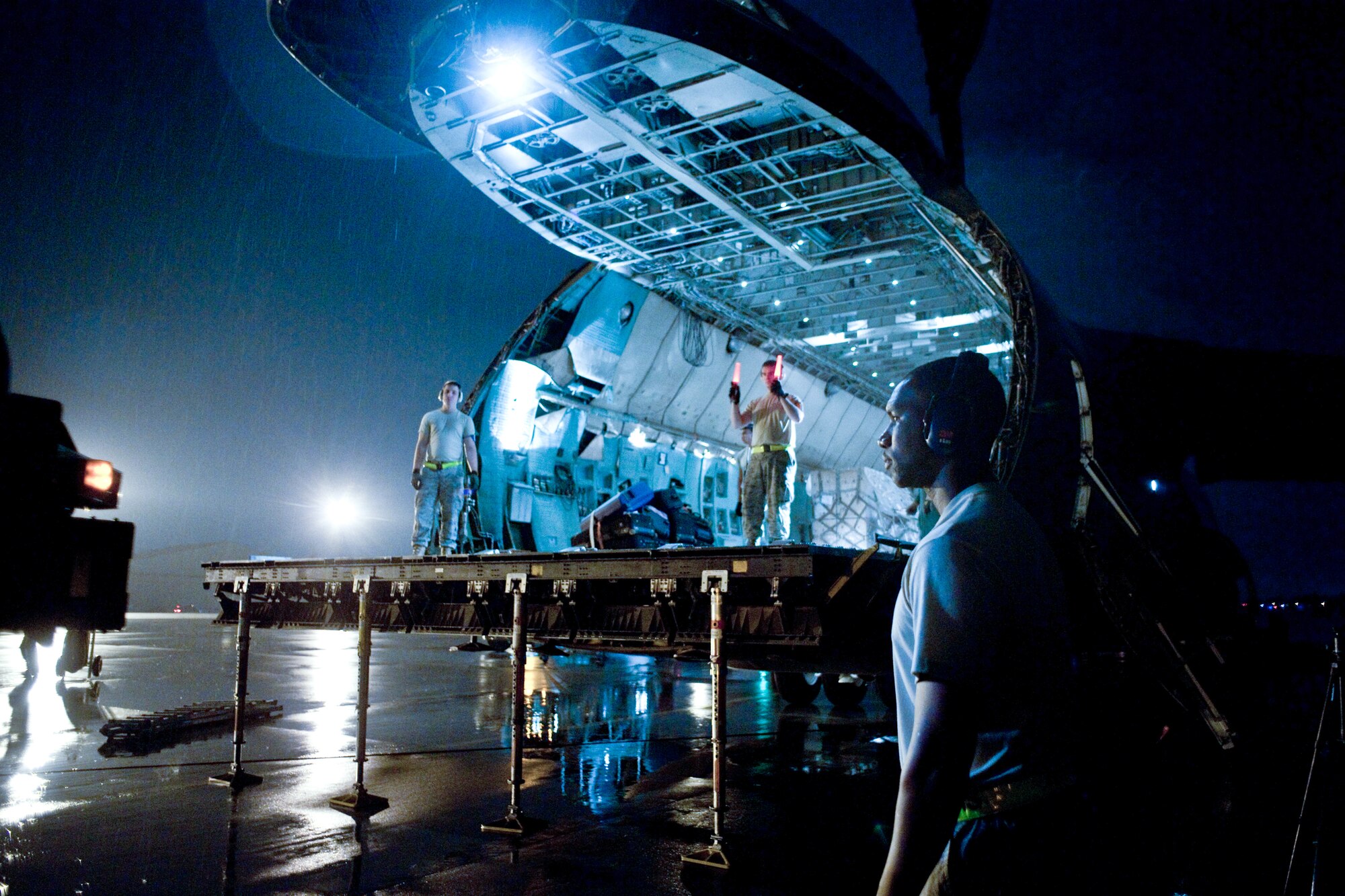 YOKTOA AIR BASE, Japan -- Members from the 730th Air Mobility Squadron guide a K-loader towards a C-5 Galaxy here Sept. 15. As the airlift hub of the western Pacific, Yokota Airmen work 24/7 operations to keep inbound and outbound aircraft running. (U.S. Air Force photo/Osakabe Yasuo)