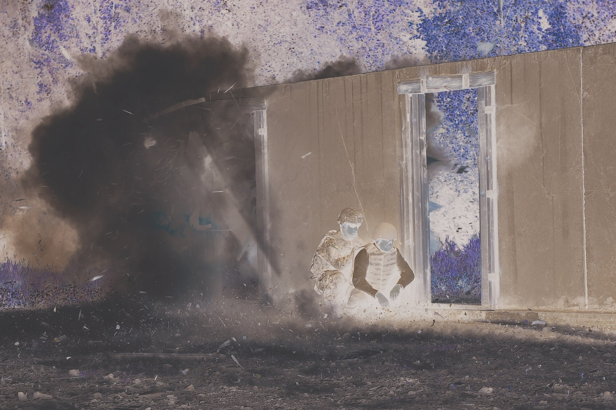 A Joint Civilian Orientation Conference participant experiences an explosion up close at the U.S. Army Alaska breach facility. (U.S. Army photo by Mary Rall/USARAK PAO)