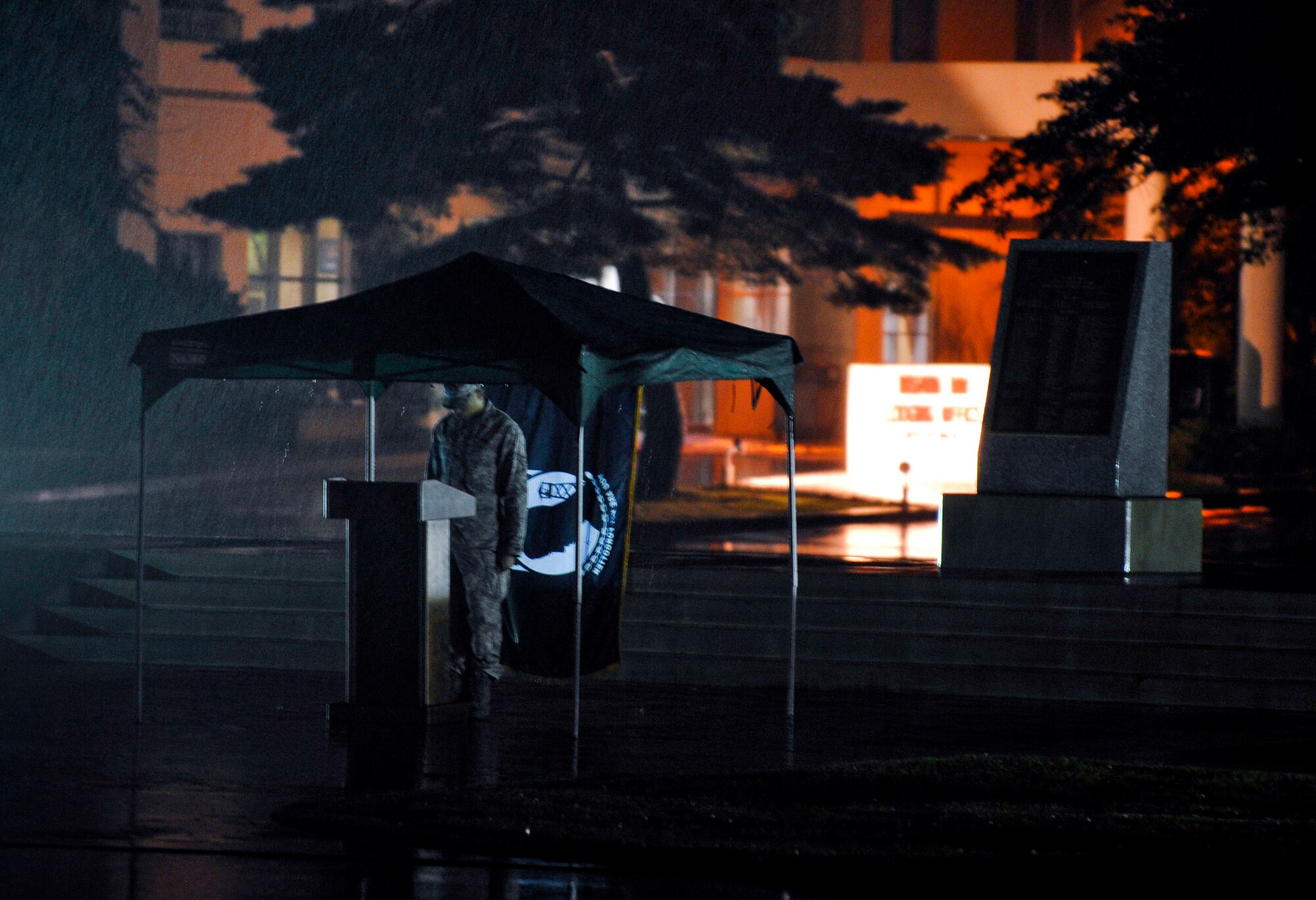 U.S. Air Force Senior Airman Willie Bivins, 35th Maintenance Squadron munitions storage crew chief, stands announcing names during the POW/MIA vigil ceremony Sept. 17, 2010, at Misawa Air Base, Japan. The ceremony lasted 24 hours, most of which, was in the rain. (U.S. Air Force photo/Staff Sgt. Chad C. Strohmeyer/Released) 
