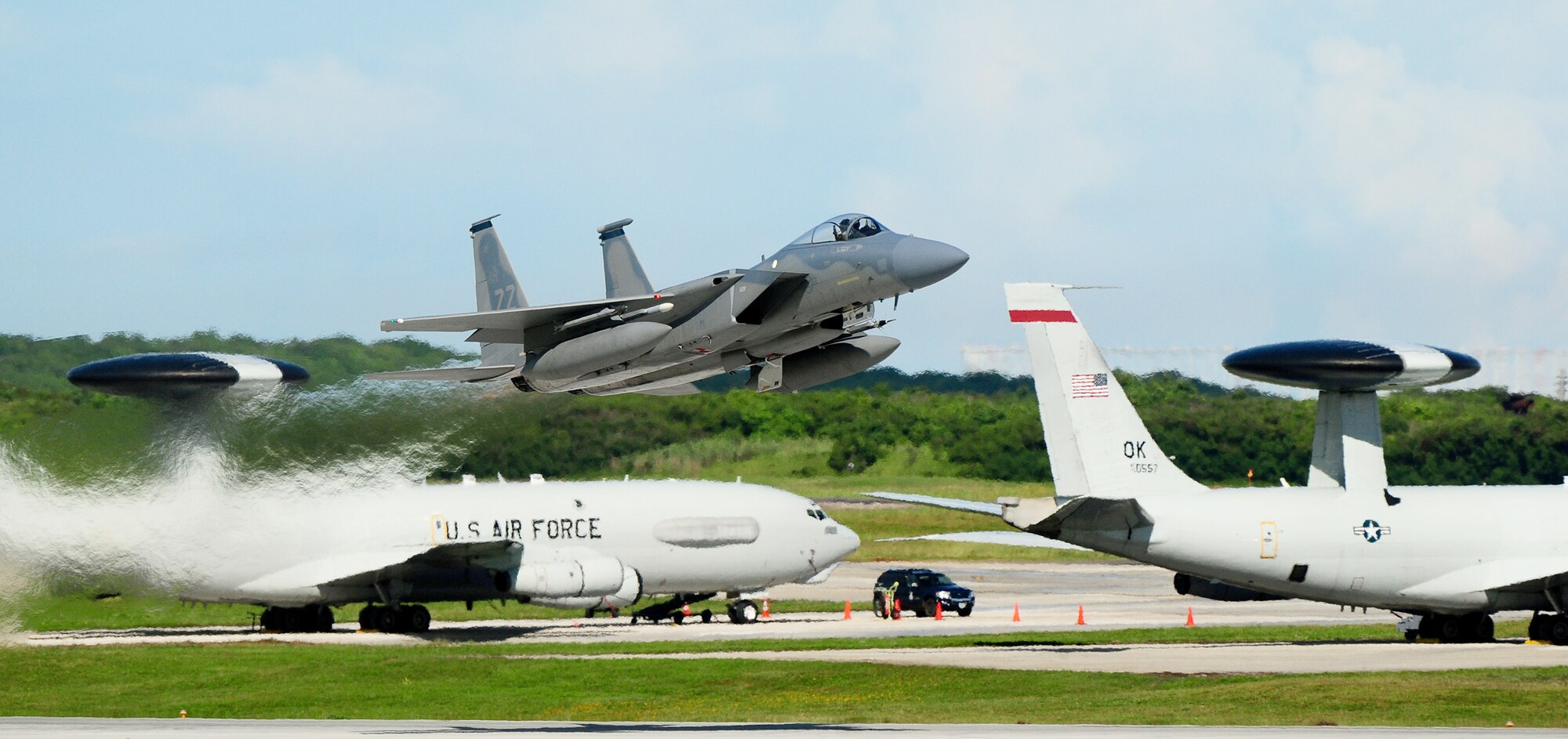An F-15 Eagle takes off from the Andersen Air Force Base, Guam, flightline as two E-3 Sentries are seen in the background while participating in the Valiant Shield 2010 exercise Sept. 16, 2010.  (U.S. Air Force photo/Airman 1st Class Jeffrey Schultze)