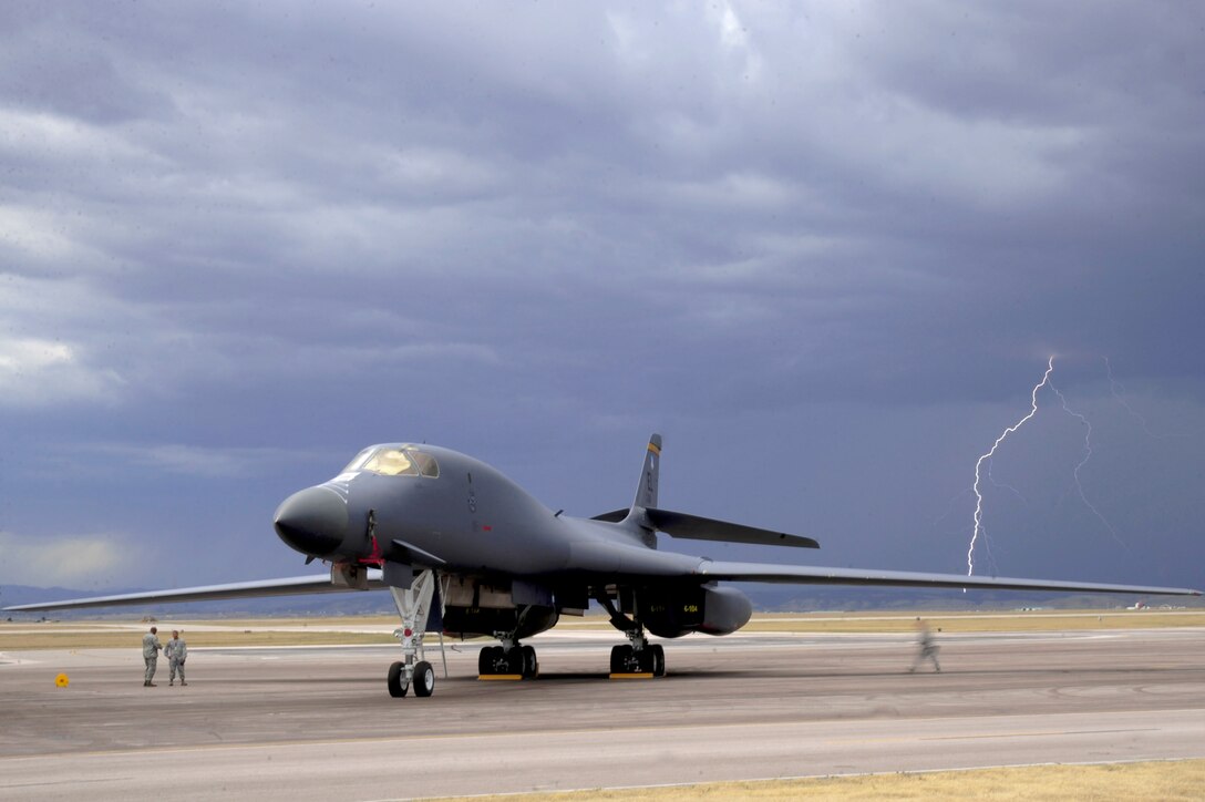 Lightning strikes behind a B-1B Lancer during an evening thunderstorm, Sept. 9, 2010, at Ellsworth Air Force Base, S.D.  The 28th Bomb Wing maintains a fleet of 28 B-1s. (U.S. Air Force photo/Senior Airman Corey Hook)