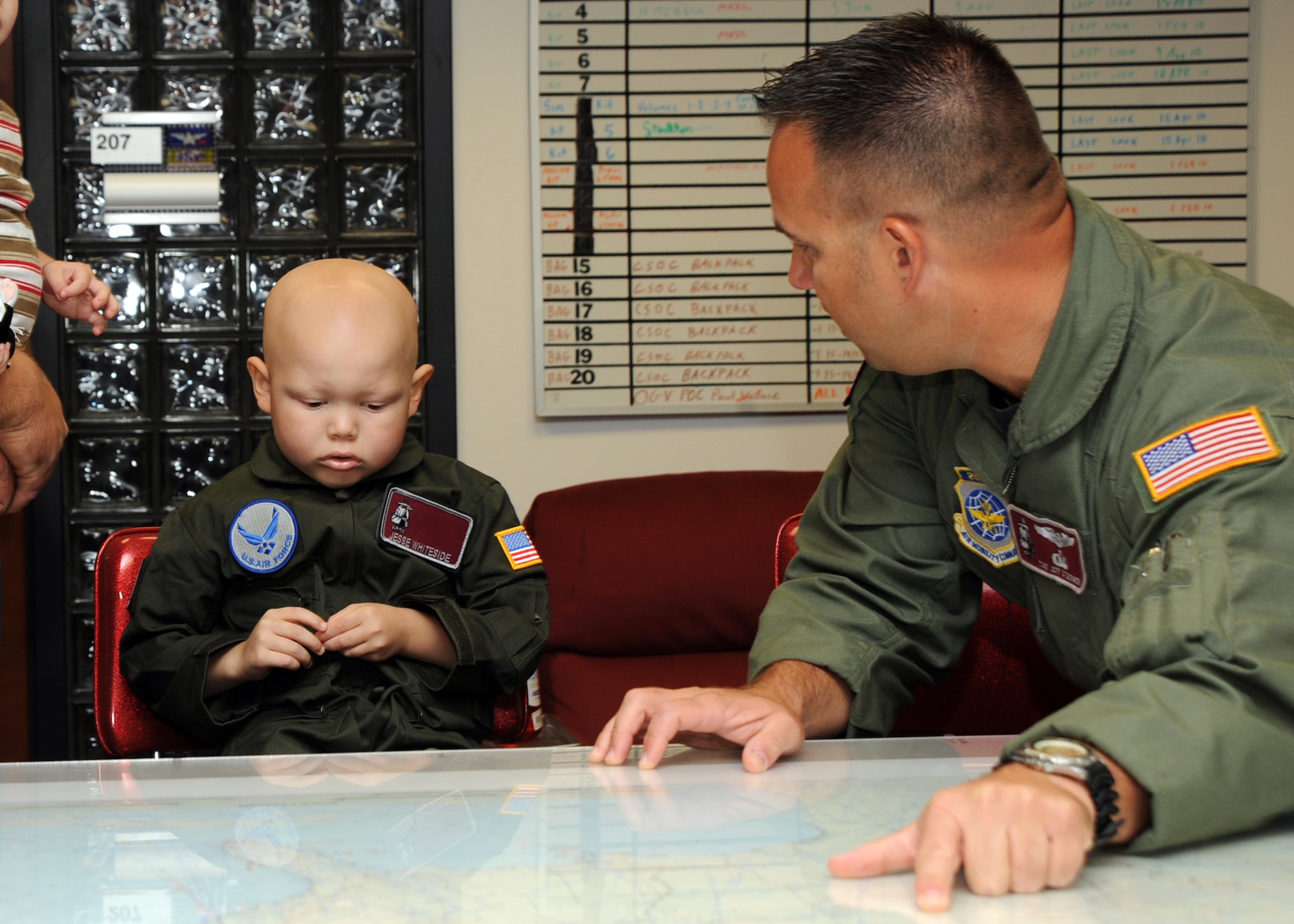 Tech. Sgt. Jeff Stoermer, 384th Air Refueling Squadron superintendant, shows 5-year-old Jesse Whiteside, “Pilot For a Day” participant, a map while explaining some of the missions that the unit does at the 384th ARS headquarters building, McConnell Air Force Base, Kan., Sept. 16, 2010.  Jesse, who was recently diagnosed with Acute Lymphoblastic Lymphoma, was invited to the base by the members of the 384th ARS as part of the Pilot For a Day program, an Air Force program that allows medically-challenged youth a chance to visit the base and participate in various activities.  (U.S. Air Force photo/Staff Sgt. Dallas Edwards)