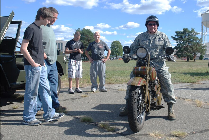 Master Sgt. Paul Gagnon, 439th Aircraft Maintenance Squadron, sits on his 1928 Harley Davidson.  The maintainer displayed his vintage bike at the Family Day car show.