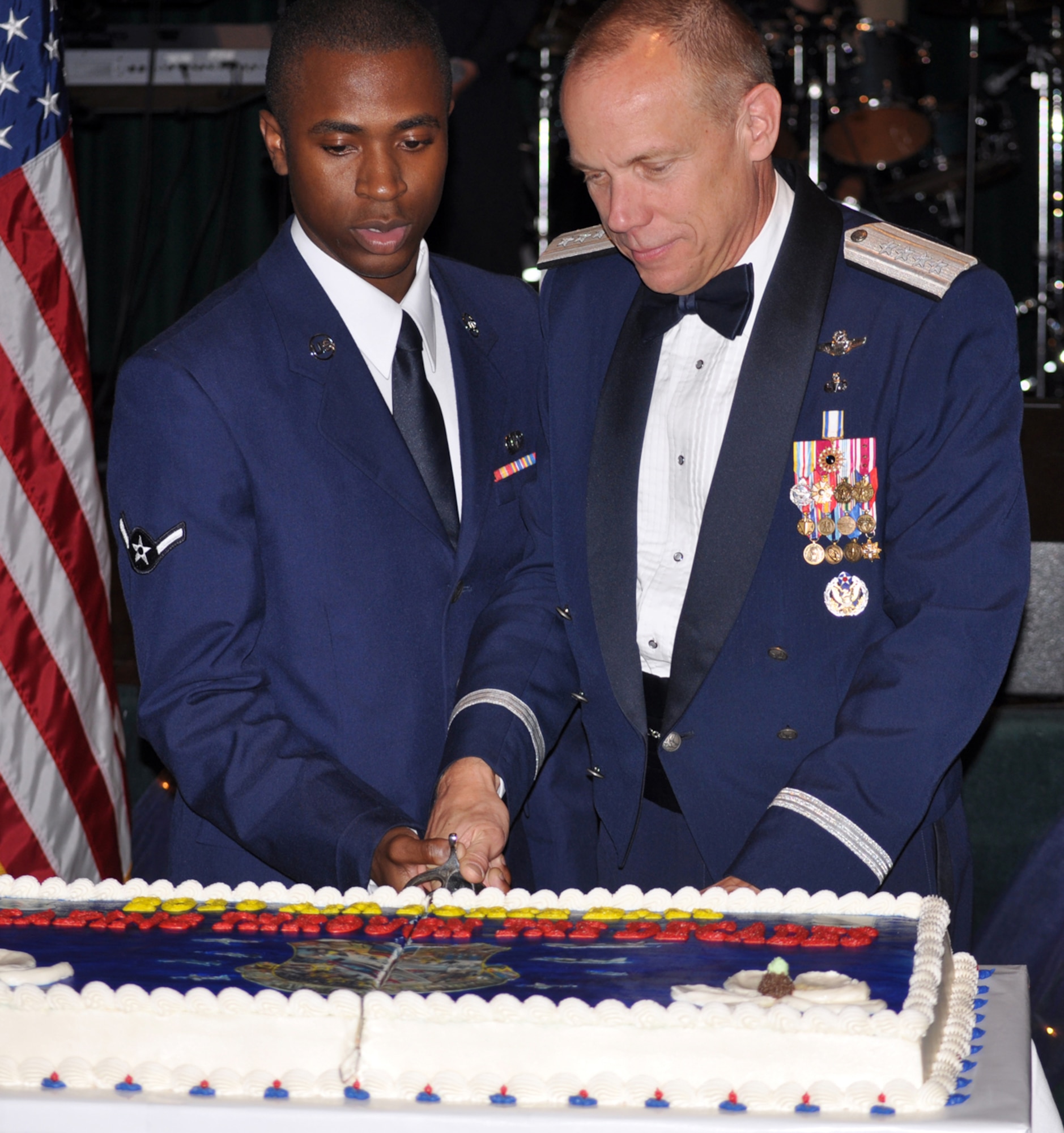Airman Tevin Moore, most junior ranking person at the ball, and the most senior ranking, Gen. Donald Hoffman, commander Air Force Materiel Command, marked the Air Force’s 63rd Birthday by cutting the ceremonial cake during the event Friday Sept. 10 held in the Trotter Convention Center. It is tradition that the most senior ranking and junior ranking members at the Air Force Birthday Ball cut the Air Force’s birthday cake together. To put the difference in rank into perspective when Airman Moore was on his way to his first day of kindergarten in 1996, General Hoffman was taking command of the 14th Operations Group at Columbus AFB. (U.S. Air Force photo/Col. George Ross). 