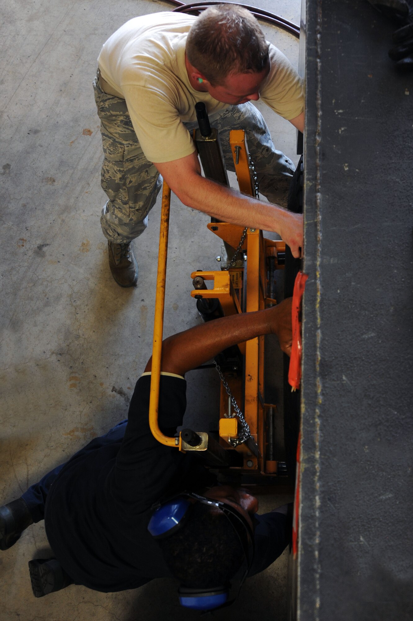 BARKSDALE AIR FORCE BASE, La. -- Vehicle maintenance mechanics from the 2nd Logistics Readiness Squadron, put a wheel back on a vehicle Sept. 14. The LRS has approximately 820 vehicles that support Barksdale?s mission. (U.S. Air Force photo/Senior Airman Brittany Y. Bateman)(RELEASED)