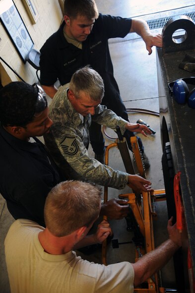 BARKSDALE AIR FORCE BASE, La. -- Master Sgt. Bobby McIntyre, 2nd Logistics Readiness Squadron, vehicle maintenance mechanic, trains Airmen with the LRS how to properly put a wheel on a vehicle Sept. 14. The LRS provides for movement of personnel and their household goods as well as shipment of all cargo. They are responsible for all Barksdale deployment functions including cargo, mobility and ready-team training. (U.S. Air Force photo/Senior Airman Brittany Y. Bateman)(RELEASED)